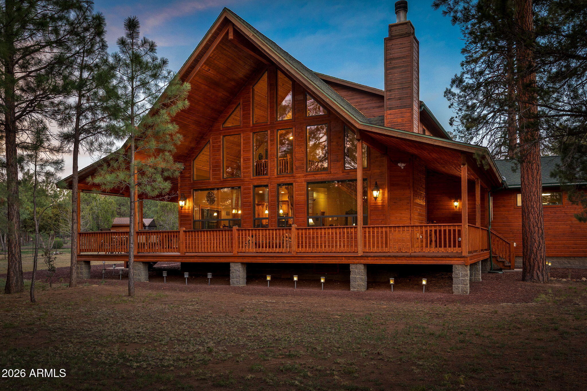 Experience elevated mountain living in this meticulously crafted chalet-style retreat in the heart of Heber-Overgaard, where towering pines create a serene, private setting. Showcasing exceptional pride of ownership, this custom home blends timeless craftsmanship with refined comfort. The main residence offers 3 bedrooms and 2.5 baths, including a luxurious main-level master suite featuring a spa-inspired bath with a rain shower, indulgent jacuzzi tub, dual vanity, and spacious walk-in closet. Rich hickory flooring flows throughout, complemented by artisan-crafted knotty alder cabinetry, solid wood raised panel doors, and a stunning floor-to-ceiling accent tree that anchors the living space. The grand great room impresses with soaring vaulted tongue-and-groove ceilings and a dramatic stone accented wood-burning fireplace with gas starter and fan, creating a warm, lodge-inspired ambiance. The gourmet kitchen is appointed with a gas range, stainless steel appliances, Sub-Zero refrigerator, and generous pantry. Upstairs, two bedrooms, a loft, and private balconies offer inviting spaces for relaxation. Outdoor living is equally exceptional, featuring a wraparound deck, covered back deck, and a private enclosed hot tub retreat. A volleyball court, RV parking, partial fencing, and paved access enhance functionality. The property also includes a 2-car attached garage and a detached 2-car garage with 840 sq ft guest quarters (2 bed, 1 bath, kitchen), perfect for hosting. Ideally located near the national forest with no HOA, this is mountain luxury redefined.