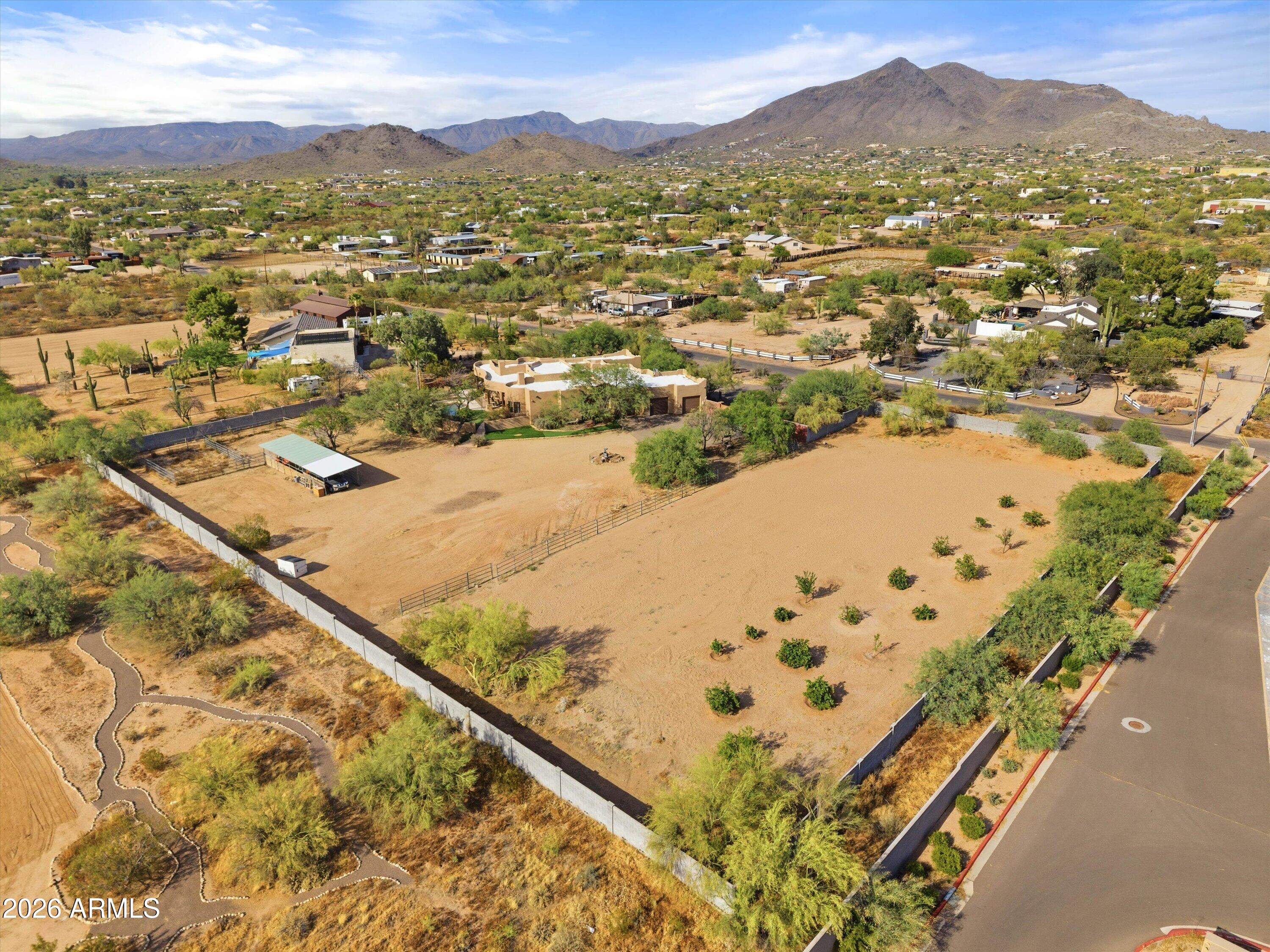 Located in a prime Cave Creek location on 2.5 acres, this updated custom Territorial home offers the perfect mix of privacy, convenience, and Arizona lifestyle living. Enjoy mountain views, stunning sunsets, and direct access to miles of hiking, biking, and horseback riding trails, all while being within walking distance to local amenities.
Recent upgrades include a new 6-ft block wall surrounding the entire property, luxury vinyl flooring throughout the main living areas, new carpet in the bedrooms, new baseboards, custom master closet built-ins, new automatic blinds, and new leach lines.
The open floor plan features warm finishes, quality cabinetry, granite countertops, stainless steel appliances, and a new refrigerator. Flexible layout offers 3 bedrooms plus a large office, theatre ro , optional 4th bedroom with separate exterior entrance--ideal for guests or a private workspace.
The backyard is built for entertaining with a Pebble Tec pool, new Bullfrog above ground hot tub, spacious covered patio, outdoor kitchen with sink, grill, refrigerator, and fireplace, all positioned to take in the views. There is also a beautiful garden & orchard with citrus and plum trees!
Equestrian amenities include a 3-stall mare motel and a large 219' x 107' arena with room to rope, rein, or team pen. Circular driveway, RV parking, and plenty of room to add an RV garage complete this exceptional property. Roof just recoated (June 2026), New AC (June 2026) and new leach field for septic (2026).