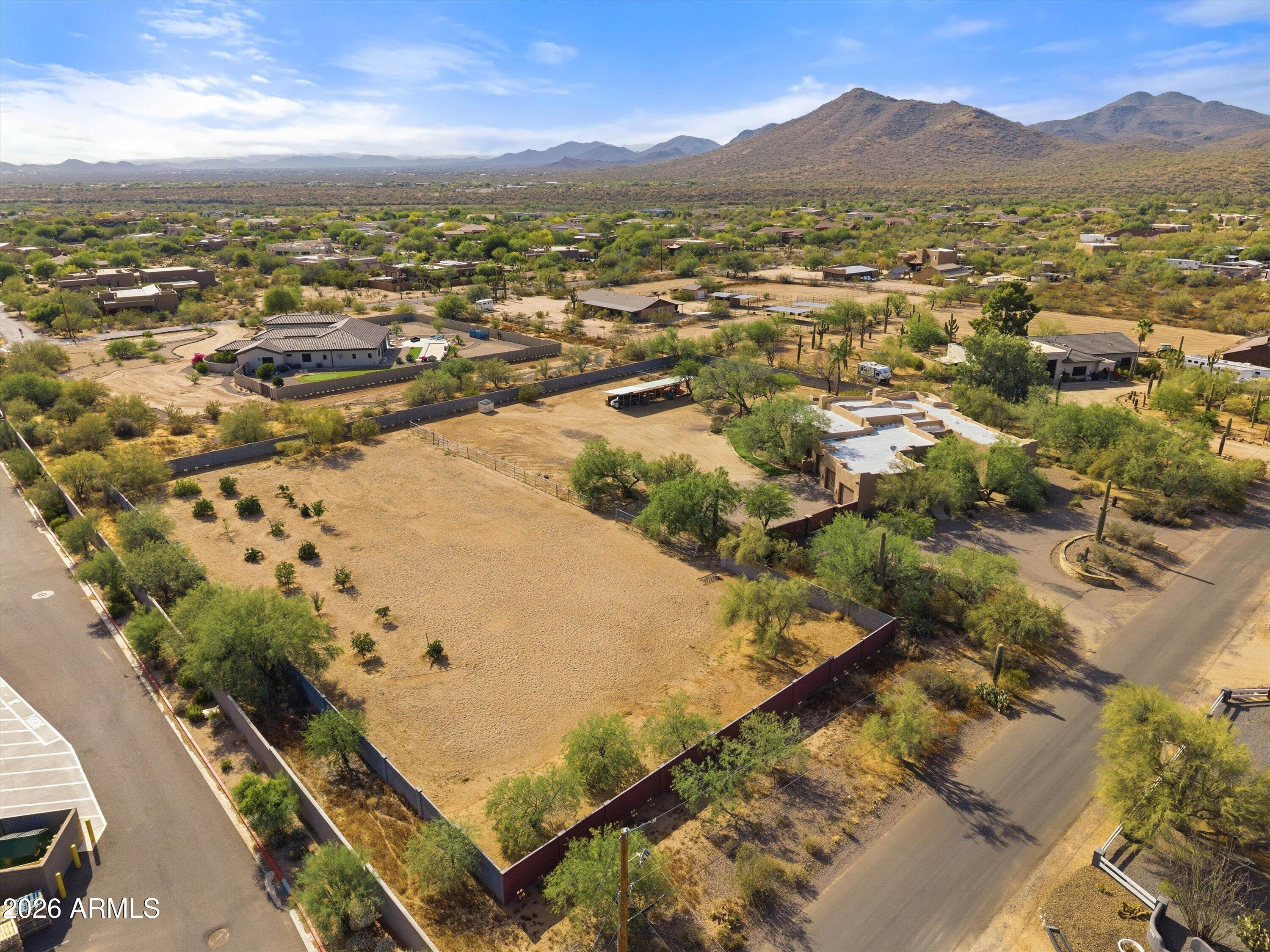 Located in a prime Cave Creek location on 2.5 acres, this updated custom Territorial home offers the perfect mix of privacy, convenience, and Arizona lifestyle living. Enjoy mountain views, stunning sunsets, and direct access to miles of hiking, biking, and horseback riding trails, all while being within walking distance to local amenities.
Recent upgrades include a new 6-ft block wall surrounding the entire property, luxury vinyl flooring throughout the main living areas, new carpet in the bedrooms, new baseboards, custom master closet built-ins, new automatic blinds, and new leach lines.
The open floor plan features warm finishes, quality cabinetry, granite countertops, stainless steel appliances, and a new refrigerator. Flexible layout offers 3 bedrooms plus a large office, theatre ro , optional 4th bedroom with separate exterior entrance--ideal for guests or a private workspace.
The backyard is built for entertaining with a Pebble Tec pool, new Bullfrog above ground hot tub, spacious covered patio, outdoor kitchen with sink, grill, refrigerator, and fireplace, all positioned to take in the views. There is also a beautiful garden & orchard with citrus and plum trees!
Equestrian amenities include a 3-stall mare motel and a large 219' x 107' arena with room to rope, rein, or team pen. Circular driveway, RV parking, and plenty of room to add an RV garage complete this exceptional property. Roof just recoated (June 2026), New AC (June 2026) and new leach field for septic (2026).