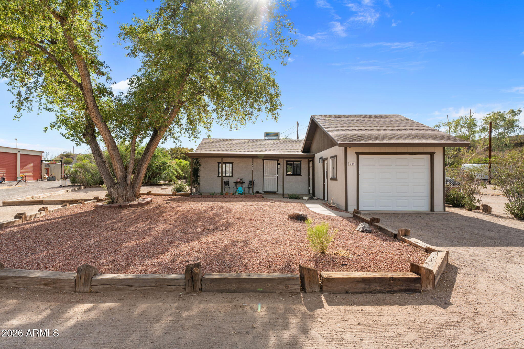 Charming home in the heart of Wickenburg! Situated on a spacious lot shaded by beautiful mature trees, this inviting property offers the perfect blend of comfort, character, and convenience. Enjoy Arizona living from the peaceful patios, surrounded by privacy fencing that creates a secluded backyard space. Inside, you'll find updated warm-toned flooring, stylish light fixtures, and modern paint colors that create a welcoming atmosphere throughout. The spacious living room provides plenty of room to relax and entertain, while the bonus room offers flexibility as a home office, den, hobby room, or guest space. Outside, the property features a 1-car garage, additional storage, RV hookup, and ample RV parking. Best of all, you're within walking distance of Wickenburg's charming downtown restaurants, shopping, and popular roping arenas, making this an ideal full-time residence, winter getaway, or investment opportunity.