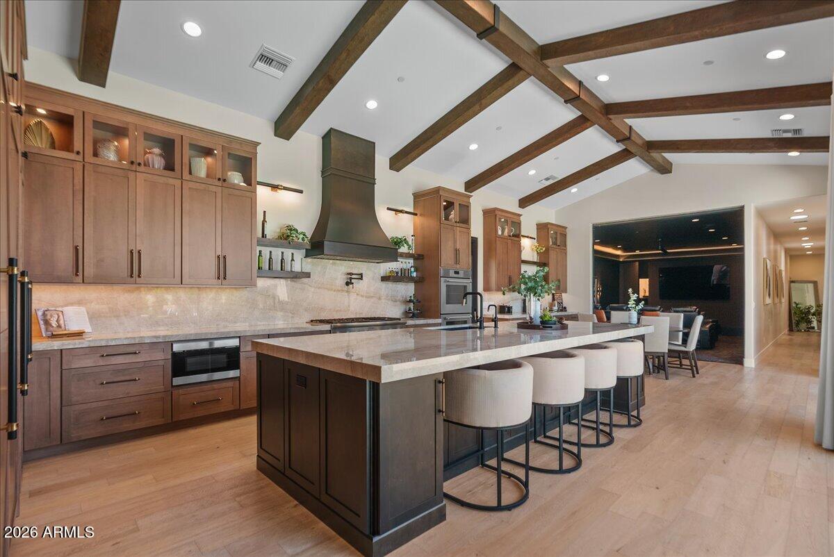 Set on an expansive lot with mountain views stretching beyond, this newly built 2024 residence was designed with a combination of formal and casual settings to host intimate gatherings to large social events. The kitchen, living, and gathering spaces were designed to bring people together--layered with custom cabinetry, natural stone, and thoughtful details that feel both refined and livable. Every finish was selected with intention, balancing warmth, durability, and timeless design.
The primary suite offers a true retreat--private, quiet, and spacious--while each additional ensuite bedroom provides comfort and privacy for family or guests. A separate guest house extends the experience, ideal for hosting or multi-generational living without compromise.
Vaulted ceilings draw your eye upwards while natural light moves through each space, creating a sense of calm and scale. Multi-Sliding Doors that blur the line between indoors and out--inviting you to step into evenings by the firepit, weekends by the pool, and mornings that begin with stillness and desert light. Beyond what you see, this home was built with a level of care that's felt more than it's noticed--from whole-home automation and integrated sound to high-efficiency systems and full-property infrastructure designed for longevity and ease.
Outside, the living continues. A newly added Baja shelf and tile to the existing pool, newly added spa, outdoor kitchen, and dedicated spaces for both entertaining and everyday life create a setting that adapts to any moment--whether it's a lively gathering or a quiet night under the stars. Separate Game Room, Theatre with sliding doors, dedicated AV room, Hidden Pantry, 2 Laundry Rooms, the amenities go on. Located in highly sought-after neighborhood with NO HOA! This is more than a home--it's a place designed to support how you live, host, and unwind. Thoughtful, intentional, and ready to be experienced. Close to the 101, shopping, walking/bike paths. Seller/Agent owned.