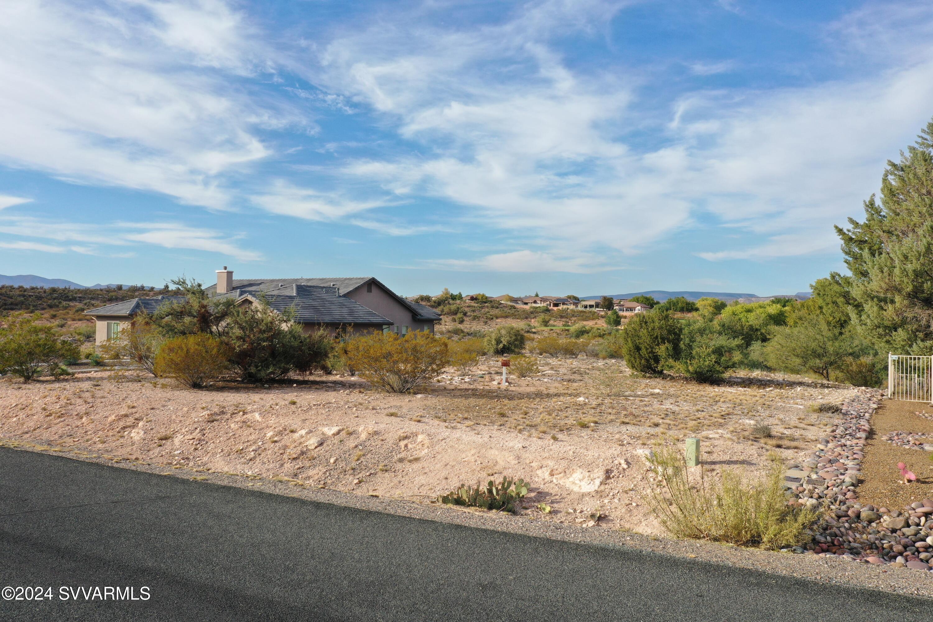 Rare opportunity to purchase vacant land in the desirable Turnberry Estate within the Verde Santa Fe Community, located directly on the golf course, this large, elevated, .35 acre parcel is ready to be built on. Enjoy wonderful view of the Agave Highlands Golf course, nearby forest service land as well is Mingus Mountain.  Underground electric, water and sewer are ready to service this parcel. Located on a dead end street!