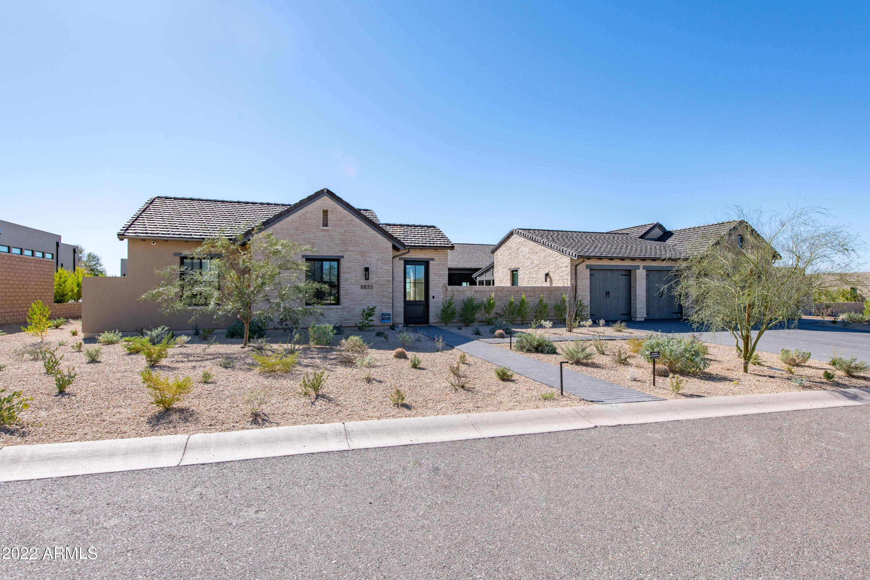 White Horse a gated community by Camelot Homes, Arizona's Most Awarded Home Builder 2020-2021. The main house includes 4 bedrooms, 4.5 baths , 4 car garage and separate 1 bedroom 1 bath guest casita. Entry to the home is through a large private front courtyard with custom water feature. Inside the home you are met with a large, bright, open great room with light wood floors. Adjacent kitchen featuring a large island, white cabinets, stone countertops, Wolf gas range,SubZero refrigerator, wine cooler, under counter refrig/freeze drawers and 2 Asko dishwashers. Outdoor living continues in the backyard with separate heated pool and spa, gas fireplace, built in BBQ, artificial tuff and desert landscaping. Enjoy beautiful sunsets with mountain views and city lights.