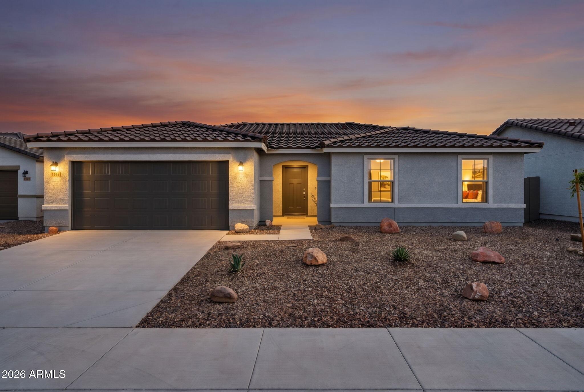 This barely lived in home gives you everything you'd want from new construction, minus the wait, the upcharges, and the post closing to-do list. It's still under builder warranty, but the work that usually falls to the buyer after closing is already done: low-maintenance front and backyard landscaping, window treatments, an updated kitchen island, and fresh, modern paint throughout.
Step inside to an open, light filled floor plan with clean, contemporary finishes -- this one's truly move-in ready and better than new! Out back, you've got options: enjoy the low maintenance yard, or build out your dream entertaining space (there's plenty of room for a pool) against a backdrop of mountain views and unbeatable Arizona sunsets.
Tucked into the sought-after Entrada del Oro community, you're minutes from hiking and off-road trails, surrounded by desert scenery, and still an easy drive to the Valley. Quiet neighborhood, connected lifestyle.
Skip the construction delays, the builder punch list headaches, and the landscaping bills -- this one's ready for you now.