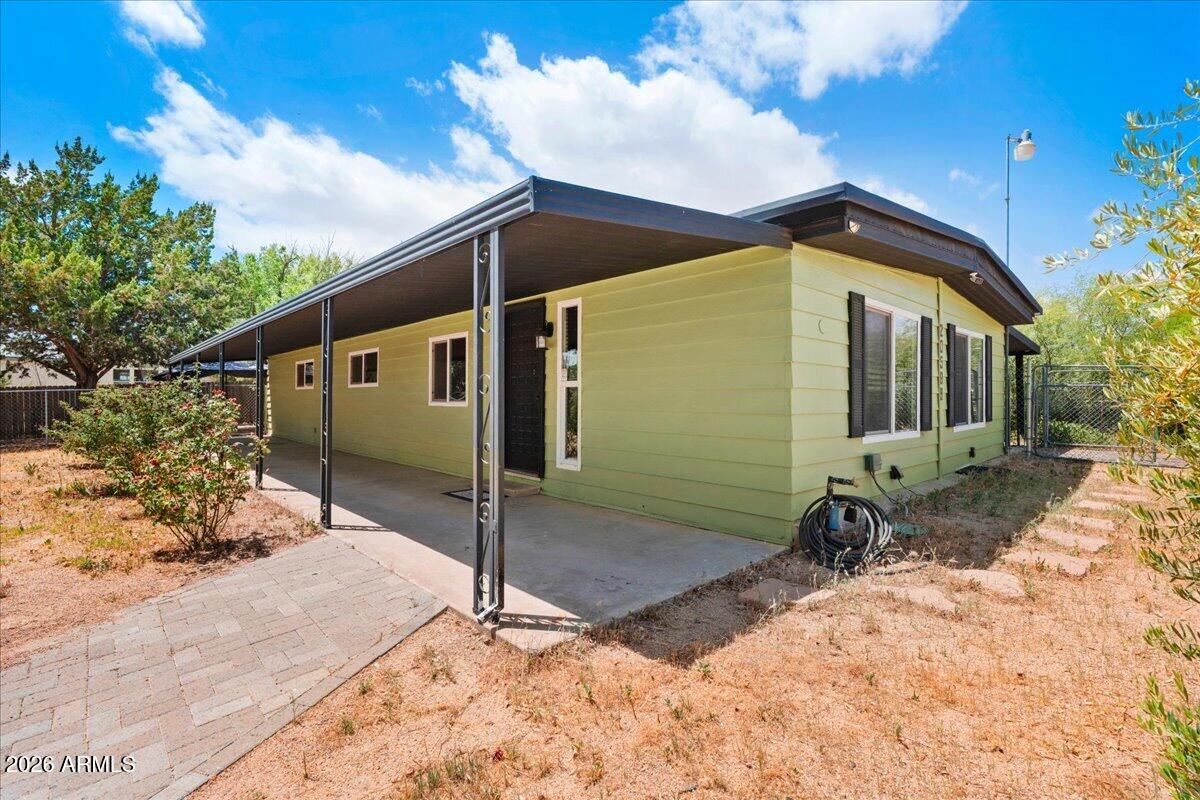 Welcome to this beautifully remodeled double-wide manufactured home offering 3 bedrooms, 2 bathrooms, and situated on a spacious .20 acre fully fenced lot.  Thoughtfully updated with a warm boho-inspired touch, this home blends modern comfort with inviting charm.  Inside, you will find gorgeous new flooring throughout, a beautifully remodeled kitchen, and stylish updated bathroom designed with both function and flair in mind.  The open and airy layout creates the perfect space for relaxing or entertaining, while all appliances convey for an easy move-in experience.  Enjoy the privacy and versatility of the fully fenced yard with plenty of room for pets, gardening, or outdoor gatherings.  This turnkey home is full of character and ready for it's new owners to enjoy. Located just 1 mile from I17 with easy access to Prescott, Prescott Valley, Sedona, Flagstaff and Phoenix!
