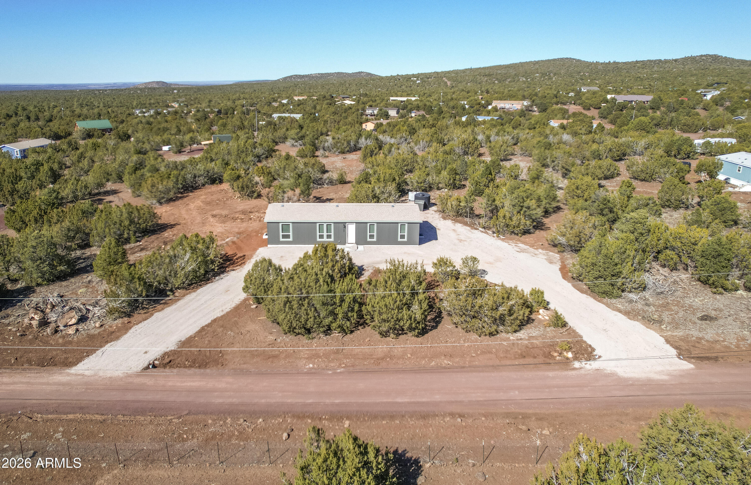 Discover comfort, space, and breathtaking scenery in this brand-new CAVACO 2026 manufactured home located in the desirable Red Lake Estate. Offering 1,600 sq ft of thoughtfully designed living space, this home features 4 spacious bedrooms and 2 full bathrooms with a split floor plan that provides privacy and functionality for families or guests. Set on an expansive 1.08-acre level lot, the property boasts excellent panoramic views, perfect for enjoying peaceful mornings and stunning sunsets. Stay comfortable year-round with central air conditioning, and enjoy the flexibility and openness that comes with wide outdoor space. Ideally located, this home is just 40 minutes from the iconic Grand Canyon, making it perfect as a full-time residence, vacation getaway. Modern, move-in ready, and surrounded by natural beauty--this property offers the perfect blend of tranquility and convenience. 
The two mile, main access road to be upgraded, no more cinder...it will be crushed rocks. It's "Working in Progress". It can be longer process but the project is already started.
Come take a look, ask for the listing agent for any questions.