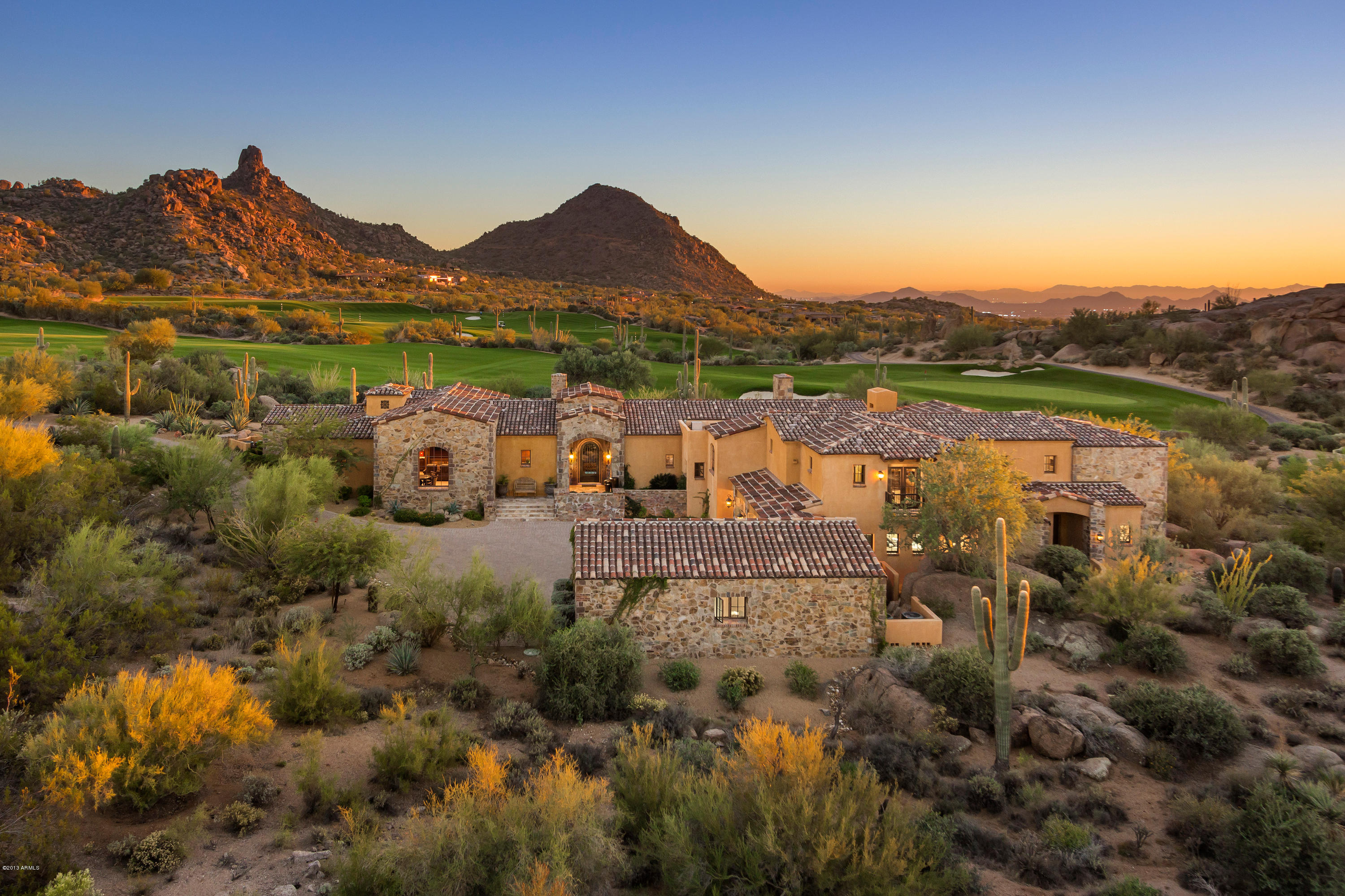 Overlooking the 1st hole of the award-winning Estancia golf course, this magnificent residence embodies all things luxury. A private drive steers you to a spacious motor court & elegant entry. Interiors designed by Est. Est., Inc. are intricate yet can stand the test of time w/ master carpentry, hand-carved Canterra, wood beam, copper and brick ceiling details, & Venetian / clay plaster walls. The dream kitchen is open to the great room w/ automated shades & a butlers pantry & wine cellar ready to service the formal dining room. The impressive theater has 3 TV's & drop down screen when it's show time. The guest wing offers two bdrm suites and family room while upstairs offers 2 bdrm suites (one as office), 2nd family room and game room. Simply fabulous!
