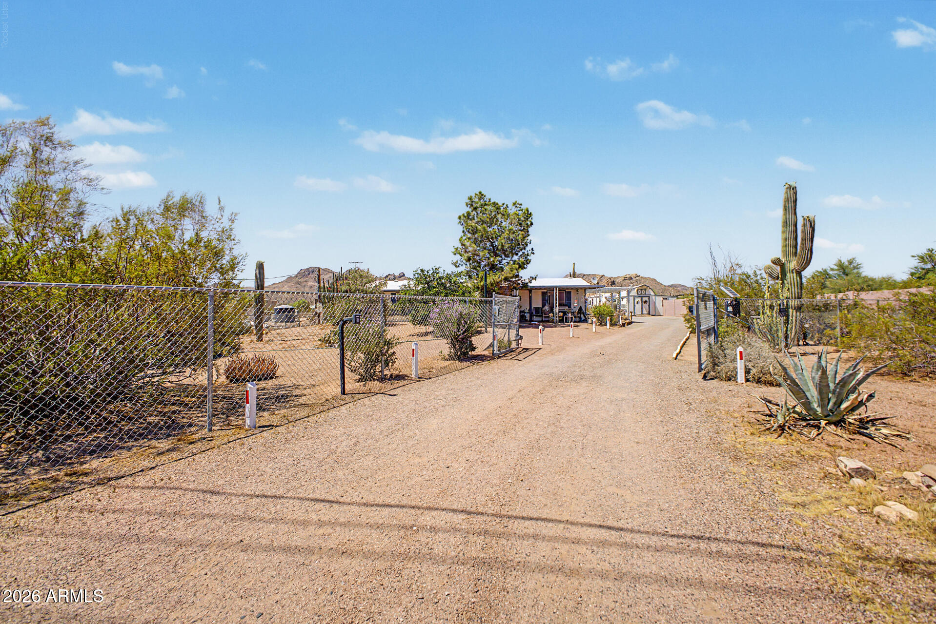 Seriously the most upgraded lot in the entire area! $10k for buyers costs & Home warranty included with this purchase.
A beautiful 1995 Cavco offers fabulous upgrades like a built on, fully enclosed, and air conditioned Arizona room.
Whole home CO2 drinking water system stays!  Washer dryer fridge stay. AC only 4 years old with 10 year warranty, all Dual pane windows. and the entire property is fenced and secured with the electric, self closing security gate out front with a pin pad and remote control.  We are on hauled water , but we have a brand new water tank underground with brand new pump. We offer a ''water truck'' that can carry 2,000 gallons 92 Chevy 1 ton 350 automatic dualie can stay with the property!  BUT WAIT...THIS IS THE BEST PART..... We have a Custom built, Steel RV garage with two bay doors, air conditioning, 220 plugins and the huge air compressor can stay! Two additional site Built Tough sheds, and a full water dripper / irrigation system throughout the whole property! Lush green trees, fruit trees and flowers. It's gorgeous! We are Paradise! And the sellers want to leave it for you! Must see! Too much to list!