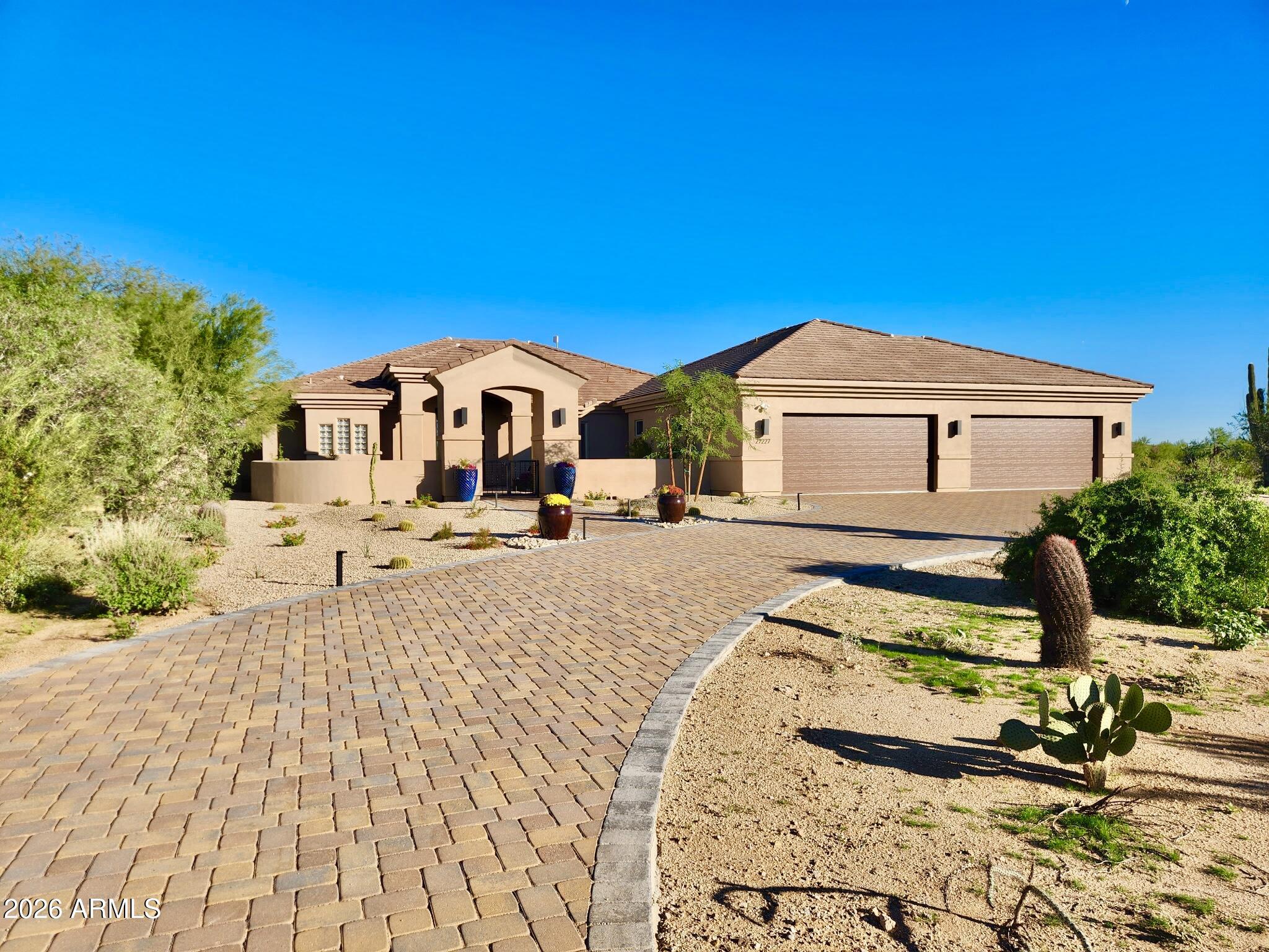 !FULLY RENOVATED! Multigenerational living at its finest! This fully remodeled North Scottsdale estate with a 1,500 sq ft addition sits on a private 1-acre lot with no HOA, surrounded by mountain views and open desert. Designed for flexibility, it offers two master bedrooms, two additional bedrooms with en-suite baths, and a spacious den. An attached 2-bedroom, 1-bath guest house adds versatility, while the extended, air-conditioned 4-car garage suits car lovers or a home gym. The bright open layout features tall ceilings, modern finishes, and energy-efficient upgrades. Enjoy a resort-style backyard with a pool, covered patio, low-maintenance landscaping, and RV or boat parking. Close to golf, dining, and top schools, this home offers luxury, privacy, and freedom with no HOA!