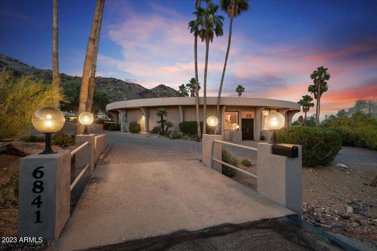 One of the most magnificent lots in Paradise Valley situated on the south slope of Mummy Mountain. Welcome to unique luxury living in this 4 bed, 3 bath, 4,759sf signature home  on 1.26 Acres with stunning Camelback views! Enter into this contemporary home with panoramic views from every room & high-quality details continue throughout.  Spacious & bright formal living room, open to the formal dining room, and into the eat-in-kitchen w/ an island, and top appliances.  Family room w/ fireplace and wet bar. XL Master suite includes a luxurious feel through the beautiful scenic views, private patio access, full bathroom w/ his & her sinks/vanities....(READ MORE) ... , stylish stand-alone shower & tub, large walk-in closet. The comforts & luxury continue into the 2 guest bedrooms.  The large 3rd guest bedroom can be used as a bedroom, office, game room, gym or all of the above. Relax, entertain & enjoy the tranquil privacy of the backyard, which is more like the 'center' yard as the home surrounds it - featuring built-in BBQ kitchenette w/ refrigerator, xl stone patio, sparkling circular pool & spa w/ breathtaking mountain views! The surrounding land is beautiful desert landscaping - room for expansion of custom garage for the car collector or significant guest house. Beautifully maintained, pride of ownership. Wonderful opportunity for your contemporary home dreams in the heart of Paradise Valley.
