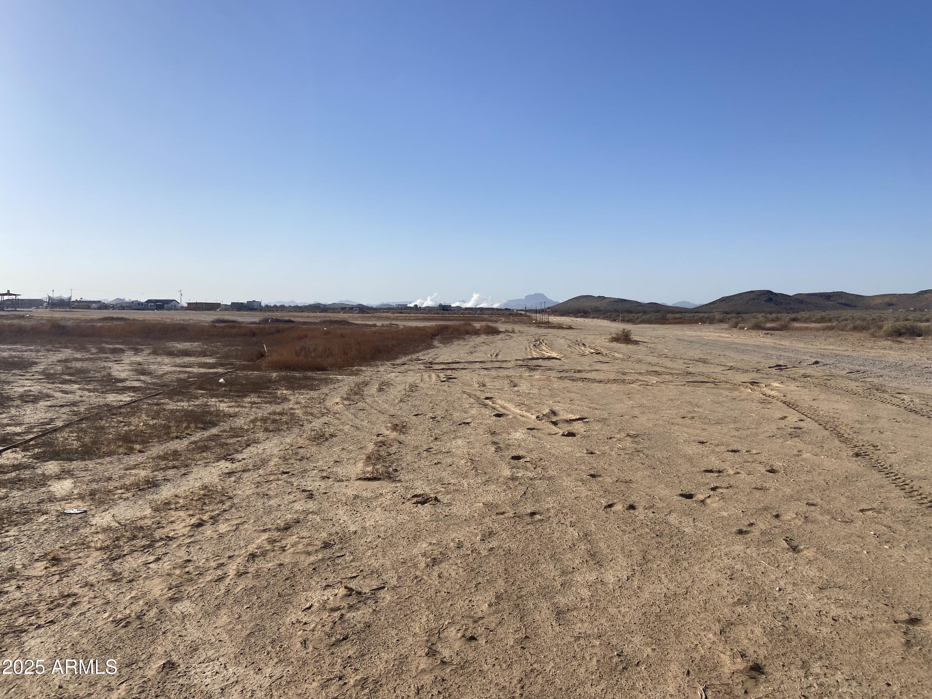 Discover an excellent opportunity to own over 4 acres of prime residential land in Tonopah! This spacious, level, rectangular lot offers stunning mountain views and convenient access to I-10 and Salome HWY, making it the perfect spot to build your dream home. With no HOA restrictions, you'll enjoy the freedom to design your ideal property. A shared well is already in place, and electricity is located nearby for easy connection. Don't miss out on this beautiful desert escape—peaceful living with room to grow!