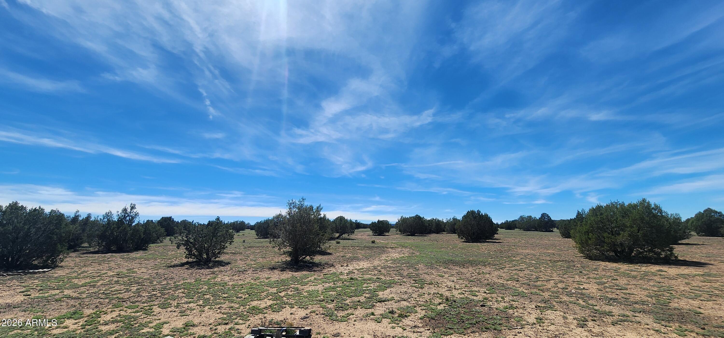 Escape to wide open space and peaceful Northern Arizona living with this beautiful 20-acre parcel in Juniperwood Ranch in Ash Fork! Surrounded by mature juniper trees and offering ultimate privacy, this is the perfect opportunity to build your dream home, create an off-grid retreat, or invest in land with endless potential. The property is already equipped with valuable improvements, including a 2,500-gallon water tank for hauled water with a solar-powered pump system--providing convenient and sustainable water access. A permitted septic system is also in place, saving you time and expense as you prepare to build. Enjoy breathtaking high desert landscapes, star-filled night skies, and the tranquility of rural living while still being within reach of nearby amenities. Don't miss this one!