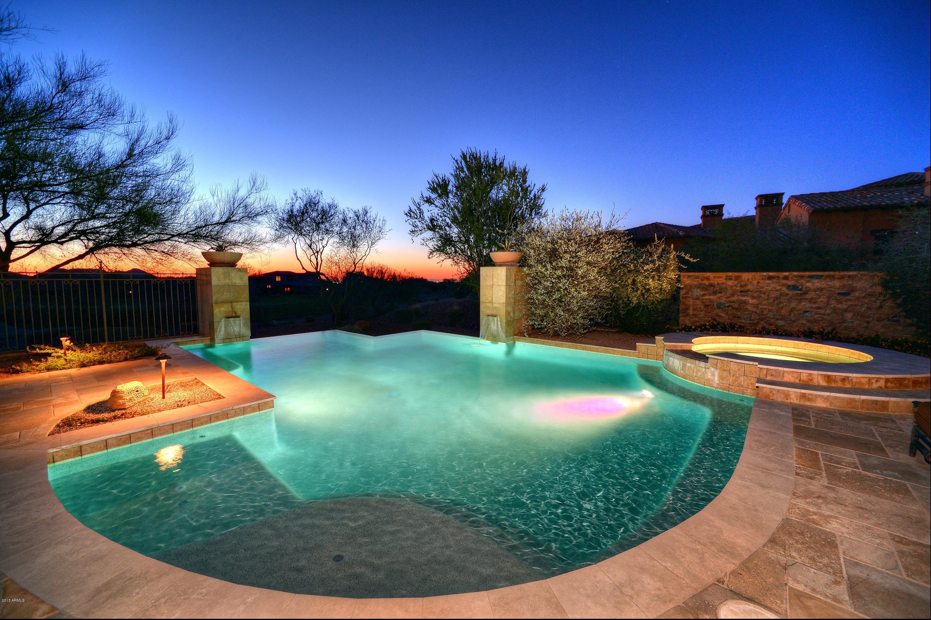 See aerial video tour under photo tab.  $3M below owner's cost. Elegant and timeless estate in Superstition Mountain Golf & CC.  Built by Montara Custom Homes, this home was designed for comfortable living with the highest quality finishes & impeccable detail.  Soaring wood beamed ceilings, chef's kitchen opens to the great room & temperature controlled wine room. The master includes sitting area w/ fireplace & elegant library, whirlpool, steam shower, sauna, his & her closets. Negative edge pool off the master, theatre room, spacious workout room.  Game room with poker table, pool table, tv's & wet bar.  Great outdoor living area with city lights.  Over $5.7M in construction & land costs, plus approx. $1M worth of furniture & design finishes.  Located in Superstition Mountain Golf & CC.