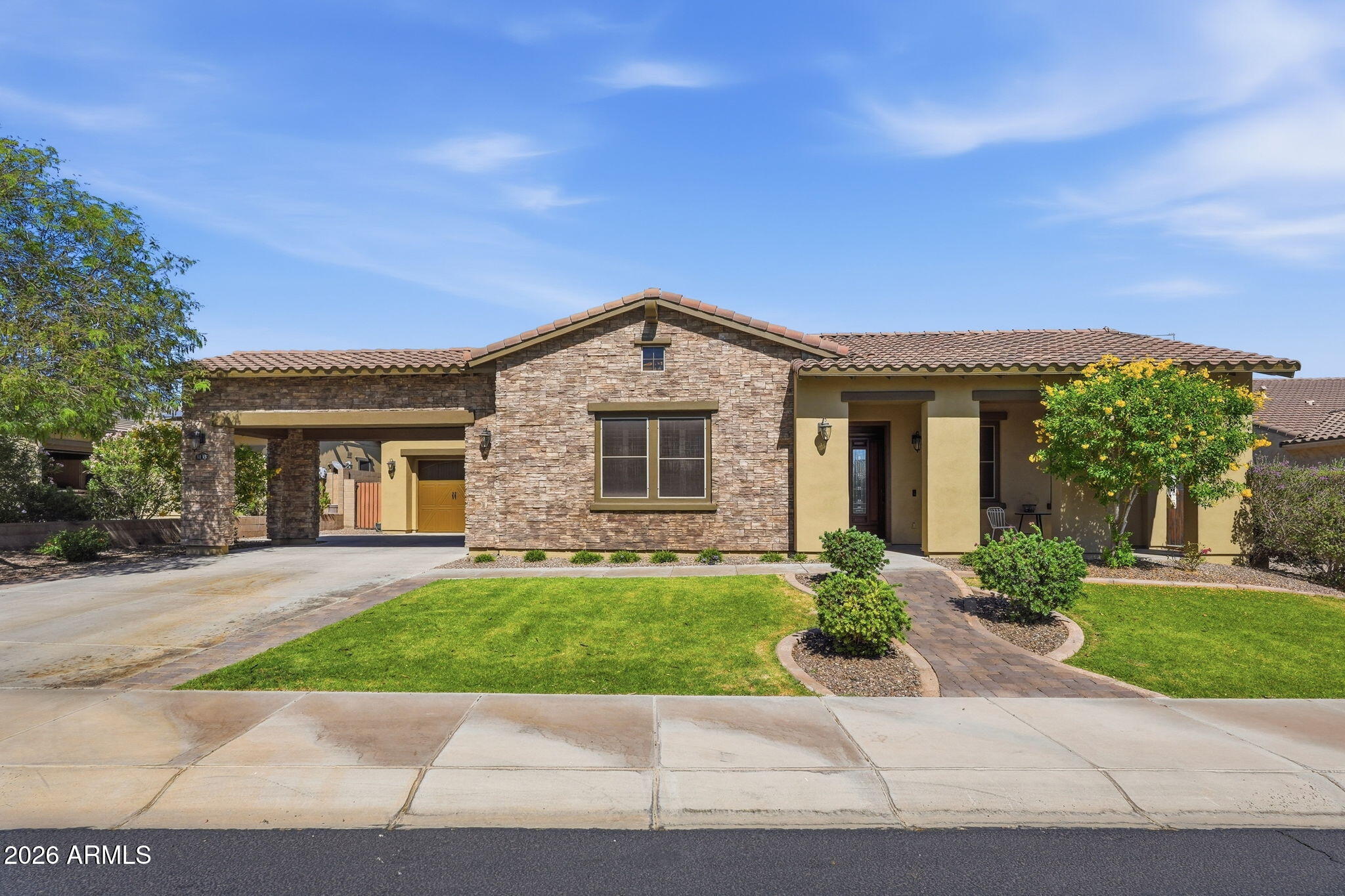 Located within the gated community of Aria at Vistancia, this coveted single-story showcases stunning stonework curb appeal, a covered carport, and spacious three-car garage. Step inside to an open-concept floor plan perfect for both everyday living and entertaining. The gourmet kitchen features granite countertops, beautiful cabinetry, a gas range, and abundant prep and storage space. A private den offers the perfect flex space for a home office or media room.

The expansive primary suite includes a walk-in closet and spacious ensuite bathroom. Step outside to a private backyard oasis with a sparkling pool, built-in grill, and covered paver patio -perfect for Arizona living. Residents enjoy access to resort-style amenities including pools, trails, tennis and pickleball courts, and more.