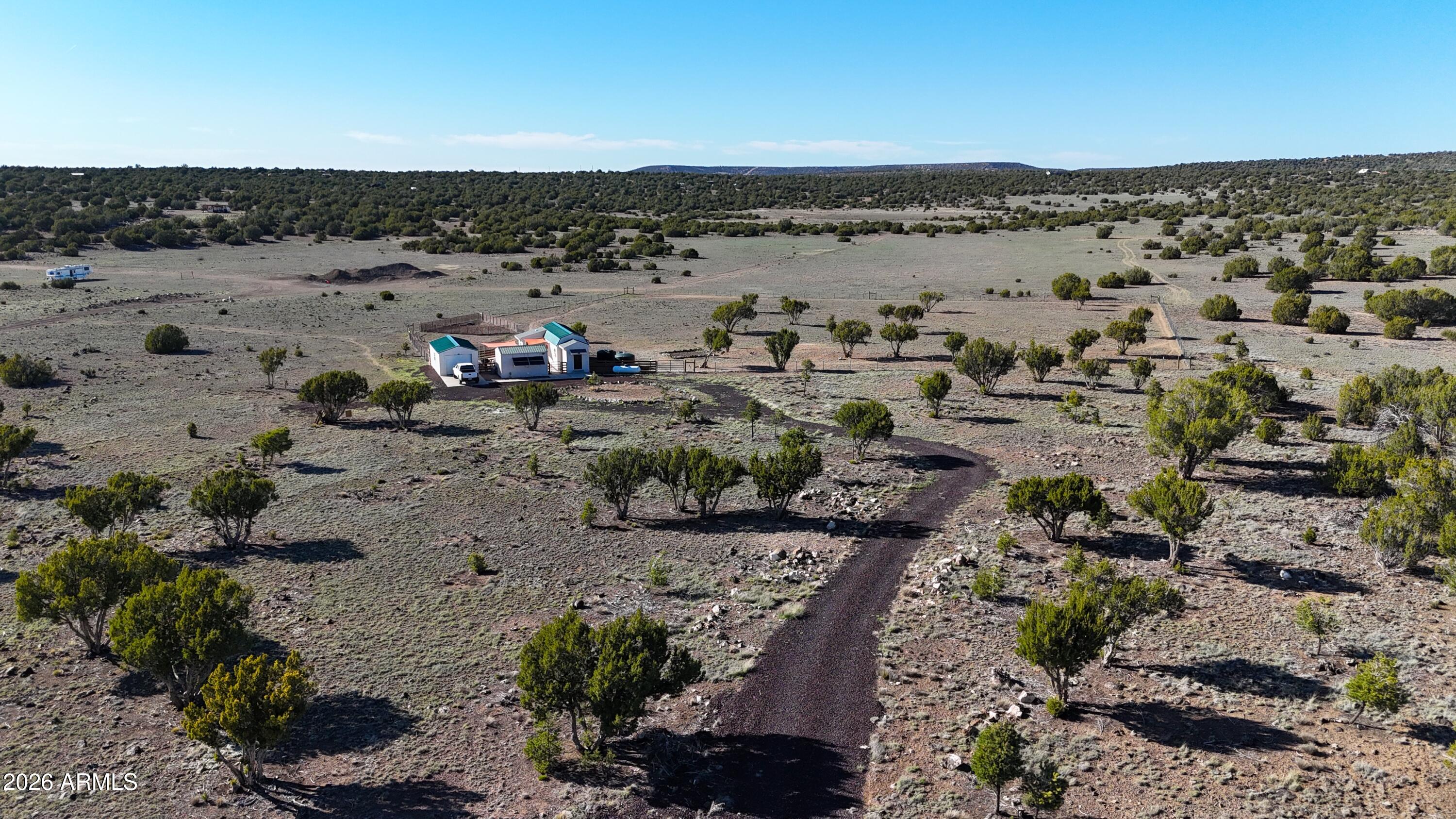 Discover your off-grid paradise on this beautiful 5-acre parcel offering privacy, functionality, and charm. The property is partially fenced and features a cozy, unpermitted 512 sq ft tiny home with 1 bedroom, 1 bathroom, and a cute, efficient kitchen--perfect for a weekend getaway or simple living. In addition, you'll find a fully insulated 24' x 14' garage, providing excellent space for storage, hobbies, or equipment. The property is equipped with an infiltrator septic system, a 48V solar power system, and an owned propane tank, giving you the benefits of off-grid living while still having power nearby for future options. Enjoy the peace and quiet of rural life while still being conveniently located just over 6 miles from a local store, bar, and restaurant, and approximately 16 miles from the town of Show Low, where you'll find great fishing, beautiful lakes, and plenty of shopping and amenities. This unique property offers a fantastic opportunity to own your own slice of Arizona countryside don't miss out, it won't last long!