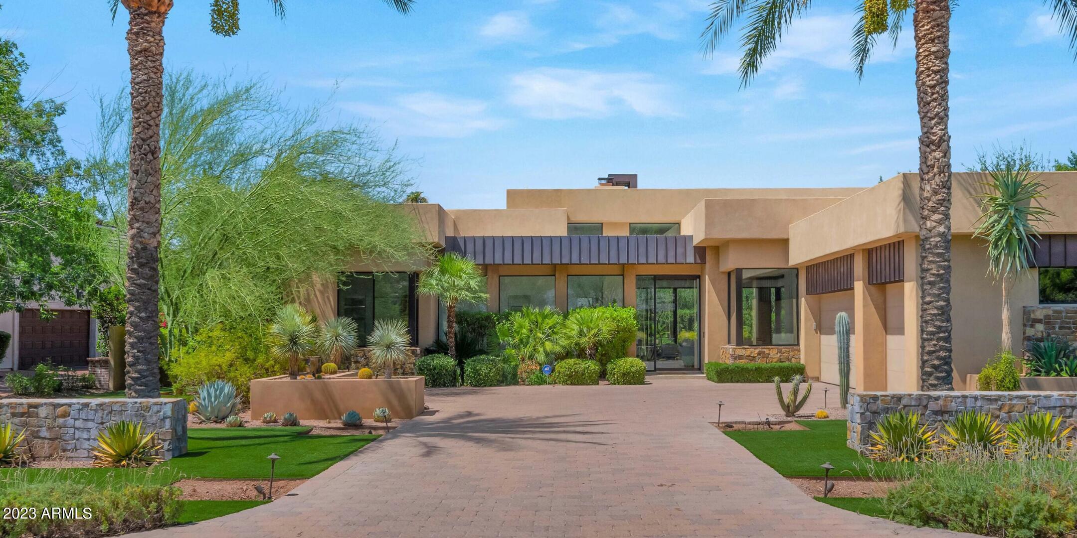 Dramatic Camelback Mountain Views from this single level 4 bedroom custom home located on the most prestigious street in Arcadia! High ceilings and open floorplan in a contemporary interpretation of Frank Lloyd Wright aesthetics. Dine while gazing at Camelback Mountain, or go for a swim in the heated saltwater pool in the very private backyard. Meticulously maintained and unsparingly upgraded — new Control 4, electric blinds, sound system, non-salt water softener, and more — this home is turnkey ready. Commercial grade misting system, outdoor fans, beautiful landscape lighting, make for incredible home to entertain! This will not last!