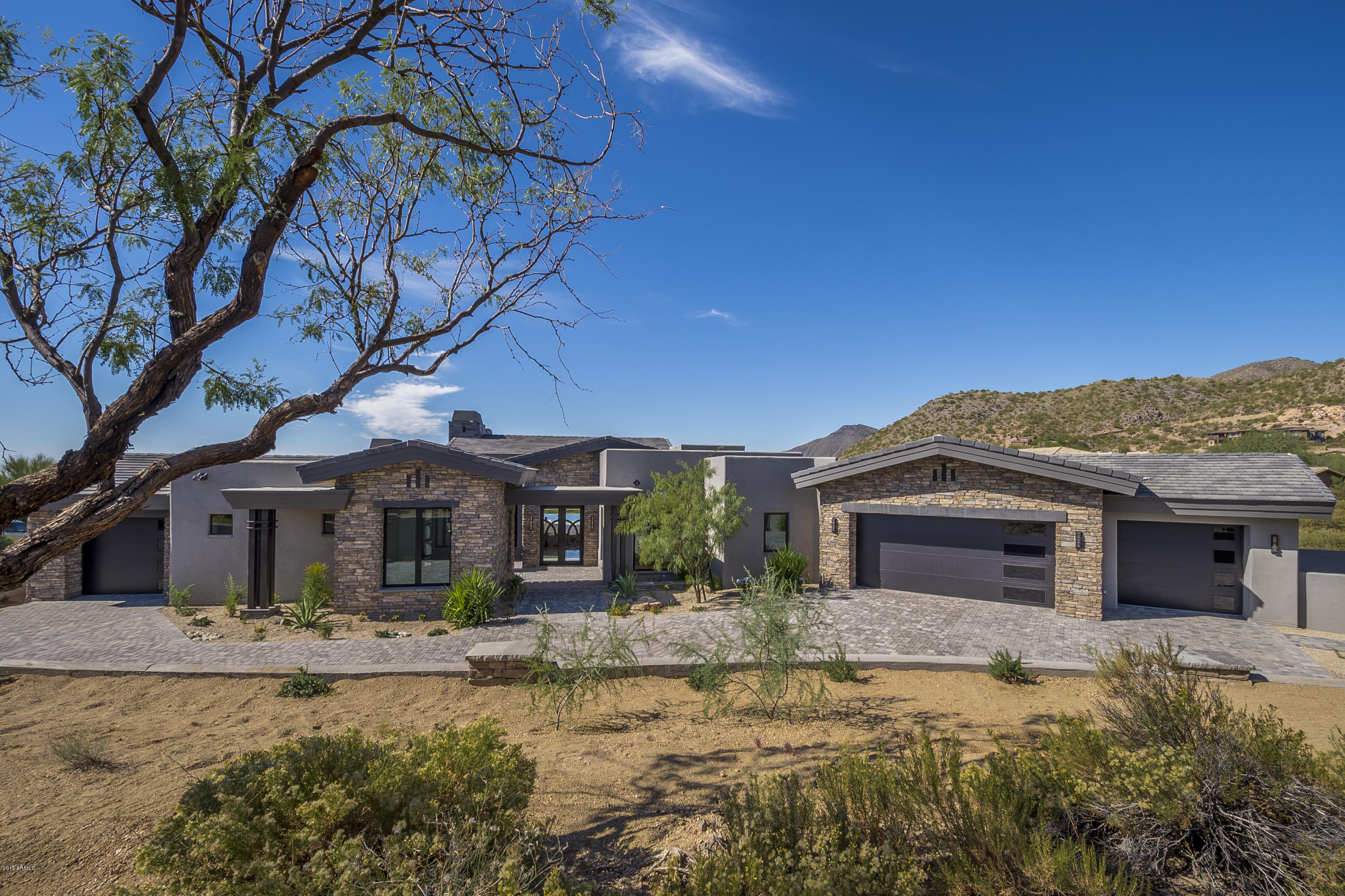 Elevated high in the Lost Star Village of Desert Mountain, this brand new custom is the epitome of modern desert living. Boasting coveted modern finishes, luxurious details, & dramatic views, this is the ultimate estate for those seeking the serenity of a North Scottsdale lifestyle. The top-of-line chefs kitchen is clad w premium finishes & fixtures incl custom Italian Alvin cabinetry, opal white granite counters, Wolf & Sub Zero appliances & spacious dining area. Spanning over 5000 SF, this masterpiece is graced w Italian porcelain tile & wood flooring, stunning fireplaces, exquisite light fixtures & intricate coffered ceilings. Sprawling outdoor entertainment spaces wrap around panoramic mountain views, custom 2 way fireplace, outdoor kitchen & negative edge pool/spa. A MUST see!