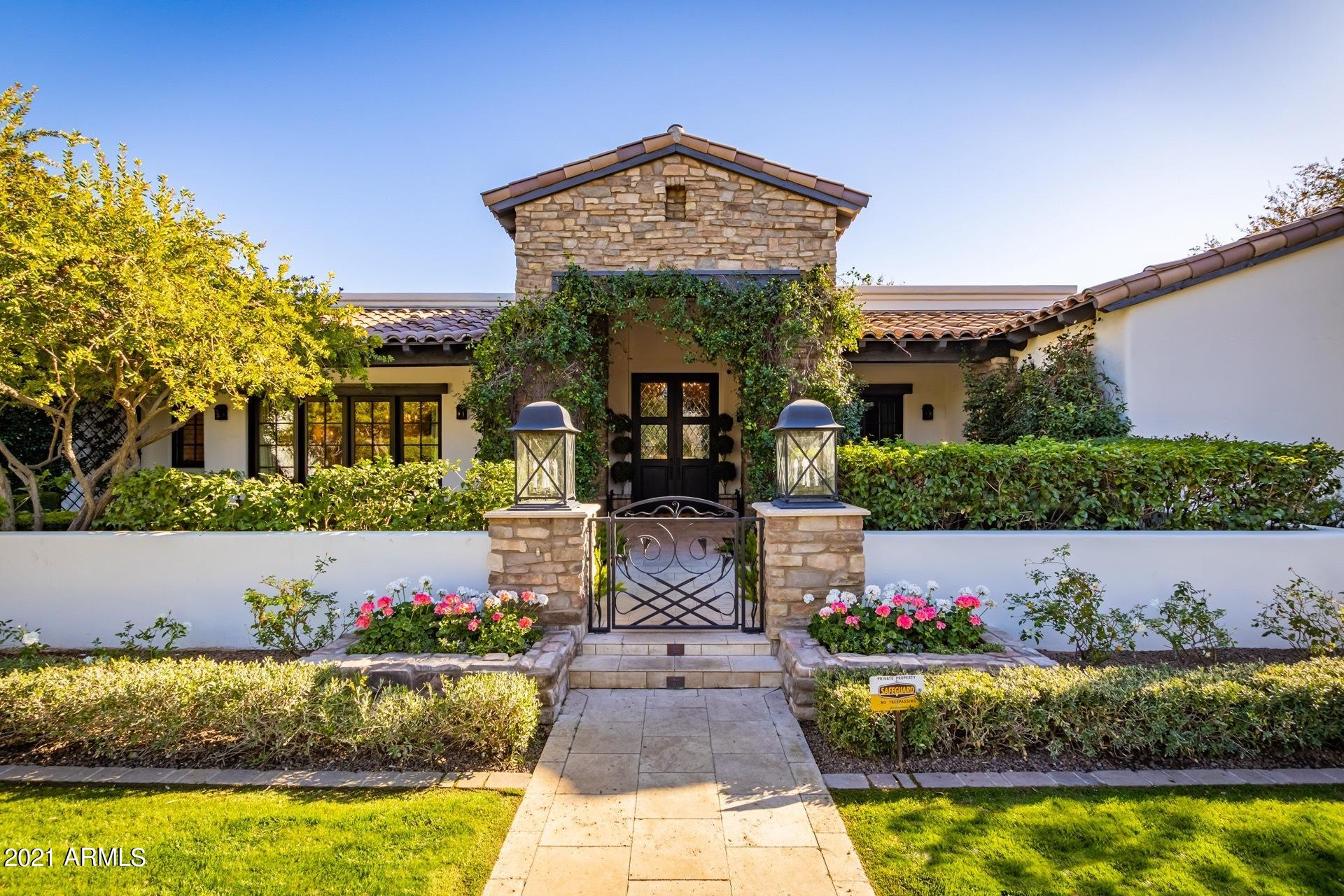 Stunning French inspired European traditional by Dana Lyon. Rose lined Berghoff design manicured walk leads to decadent entry pouring into open pocket doors for indoor/outdoor feel. Country club preppy Beverly Hills Peninsula Hotel inspired pool and yard with jet fountains, new turf and pickle ball sport court, retractable batting cage, secret gardens and up-lit resort style palm trees, truly the best yard in Arcadia proper. 1.2 acres of private sanctuary behind guard gates yet right in the middle of the best shops, restaurants and steps from Scottsdale Fashion square. 4 en-suite bedrooms plus two offices, kids living and formal living. Rich stones with wood inlay, high ceilings and detailed built ins. Timeless elegance and featured in multiple magazines.  No powerlines and private drive.