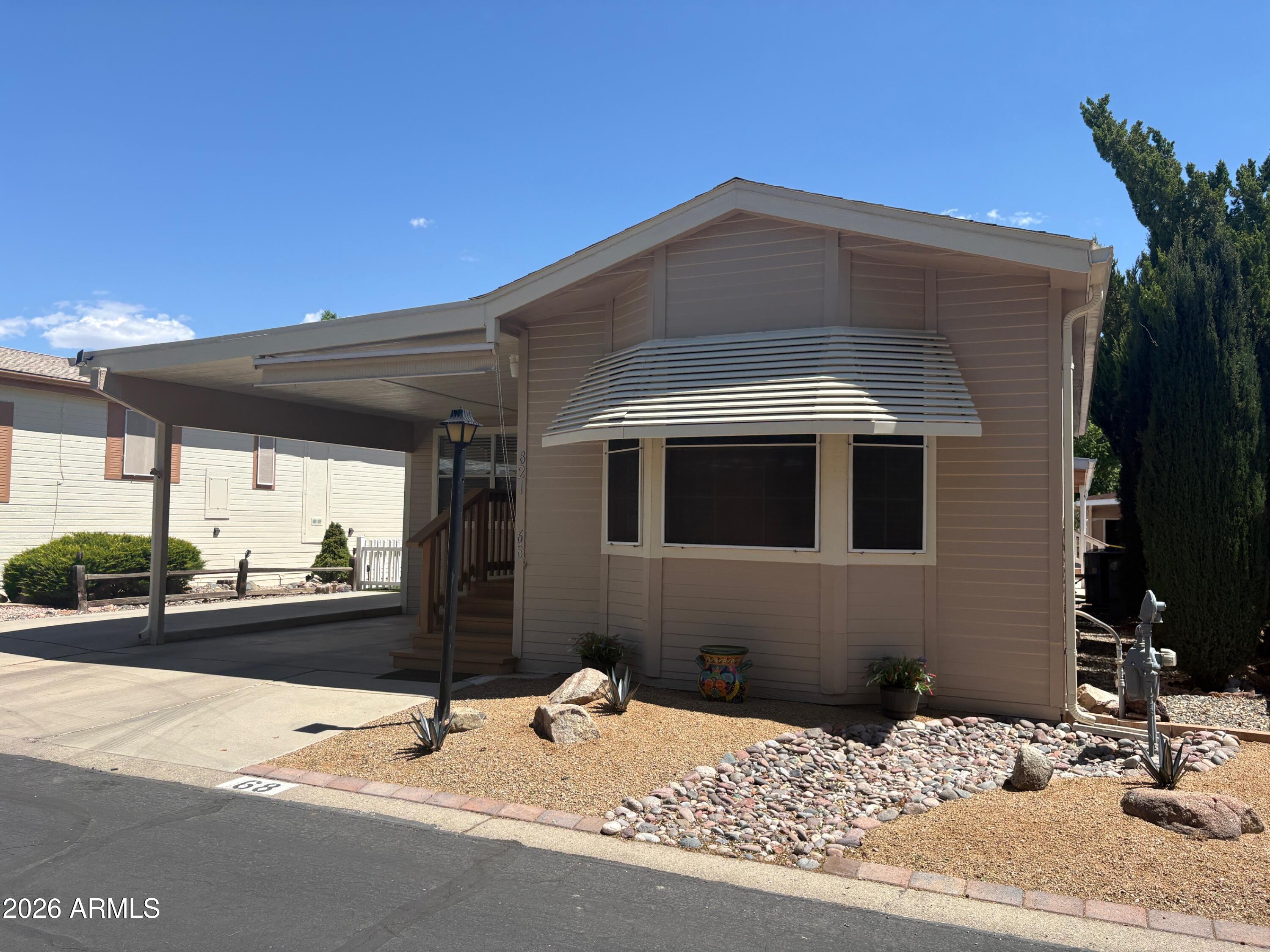AN AFFORDABLE AND PERFECT 2nd Home or a great place to live year-round. Expanded Cavco Home in a 55 PLUS COMMUNITY. You own the lot! It has a living room, kitchen, 1 bdrm, and 2 bathrooms. The great room is large and has a pull-out sofa. Kitchen/Dining with office niche. Furniture is like-new. New roof in 2023, new heat and AC in 2024, new hot water heater and microwave in 2025. Full-size washer/dryer. New exterior paint, private patio, shop/storage room with electric. 2-car parking, one covered. All play and no work! You'll enjoy a beautiful, heated community pool, social activities galore, a heated indoor spa, a pickleball court, and a tennis court. HOA is $150 and includes sewer, water, and trash service. Enjoy a hometown atmosphere with a mild, 4-season climate, ALL AMENITIES NEARBY.