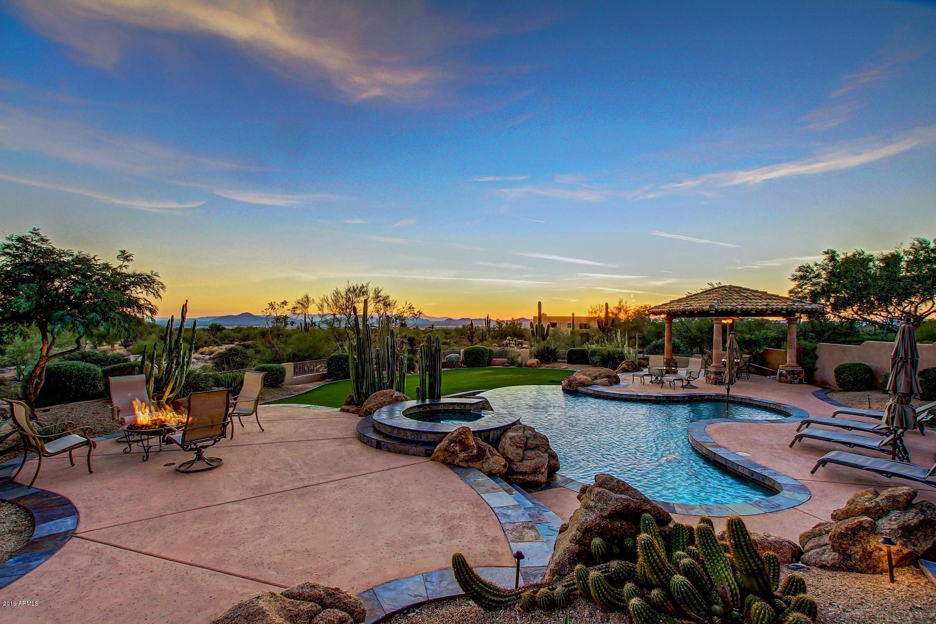 Stunning 12.2 acre estate nestled at the base of the McDowell Mountains. This exclusive property offers breathtaking unobstructed city, mountain & sunset views. This privately gated home offers warmth, luxury & easy living through masterful design and timeless architecture. Open floor plan features beautiful formal & casual spaces for family & entertaining with peaceful desert views from every room. An open chef's kitchen, beautiful bar, amazing walk-thru pantry, & unique pool bath add both style and function to this special home. Bedrooms are ensuite with walk-in closets & private baths.  The luxurious master suite has sitting room & view deck with panoramic views,  relaxing bath with Jacuzzi tub, and his & her's custom closets. Magnificent outdoor spaces with infinity edge pool & spa. Don't miss the 900sf luxury, temp controlled garage and workshop! This property is zoned for horses.
