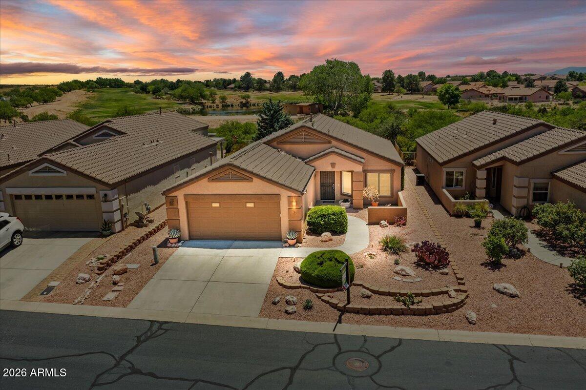 Welcome to this wonderful one-story, two-bedroom home located in the highly desirable Amante at Verde Santa Fe subdivision. Situated on a premium lot with breathtaking long-range mountain views, this beautifully maintained home backs to the 17th tee of the golf course, offering both privacy and scenic surroundings.This open-concept floor plan features numerous updates throughout, including new appliances, a new HVAC system, new furnace, newer hot water heater, updated plumbing fixtures and toilets, and fresh exterior paint. The spacious primary suite offers a large walk-in closet, and new flooring is currently being installed in the primary bedroom to seamlessly match the rest of the home.Designed for easy living, the property features upscale low-maintenance landscaping Front & back yard.