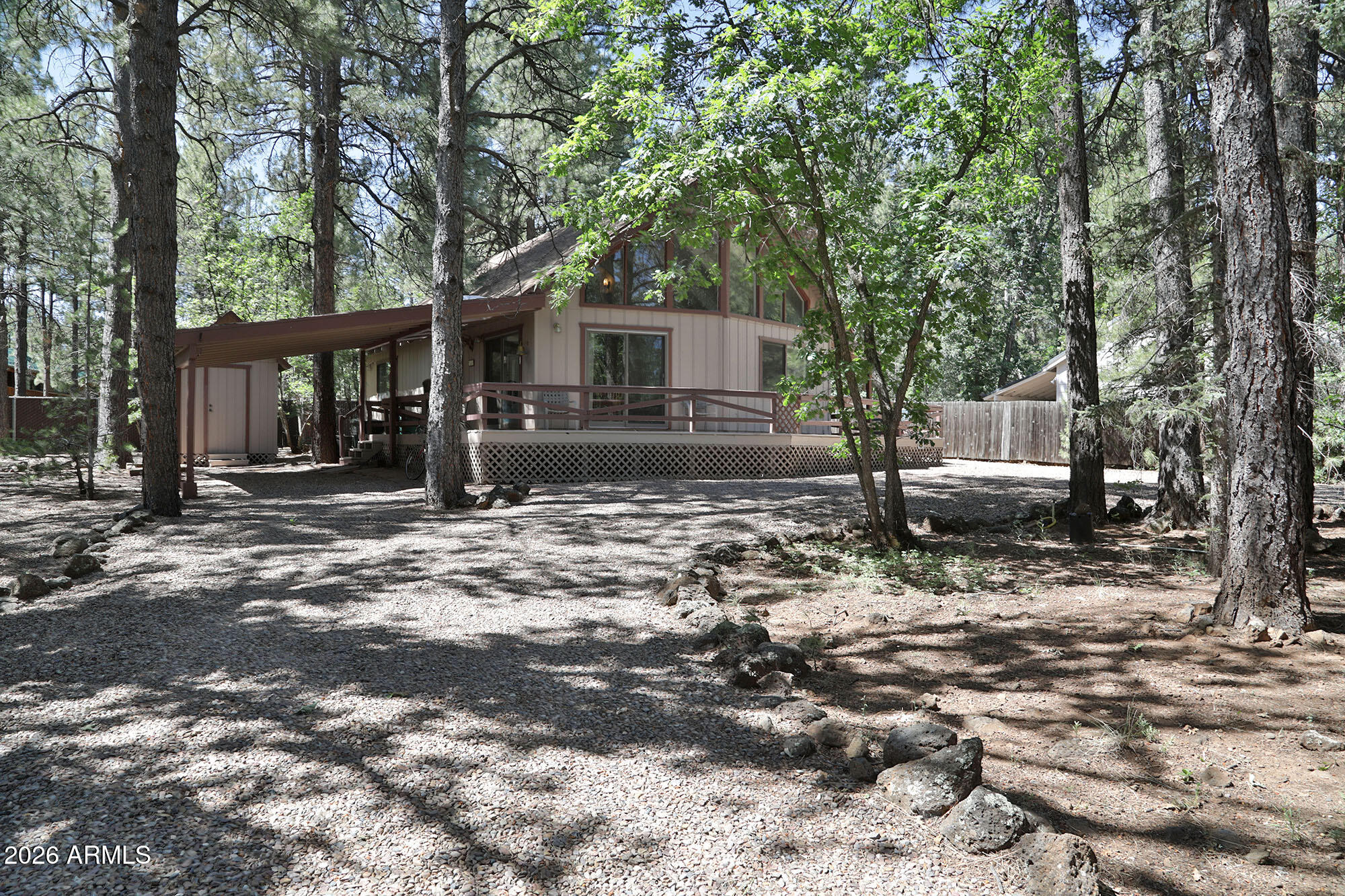 Great chalet-style home with easy year round access. A wall of windows provides an abundance of natural light. Wrap-around deck is partially covered. In addition to the two bedrooms there is a large loft with a full bath and small outdoor deck. Lot is heavily treed with mature ponderosa pines, oak trees and no-fuss landscaping. Circular driveway, one-car carport, well-built utility building and membership at the Pinetop Lakes Association.
