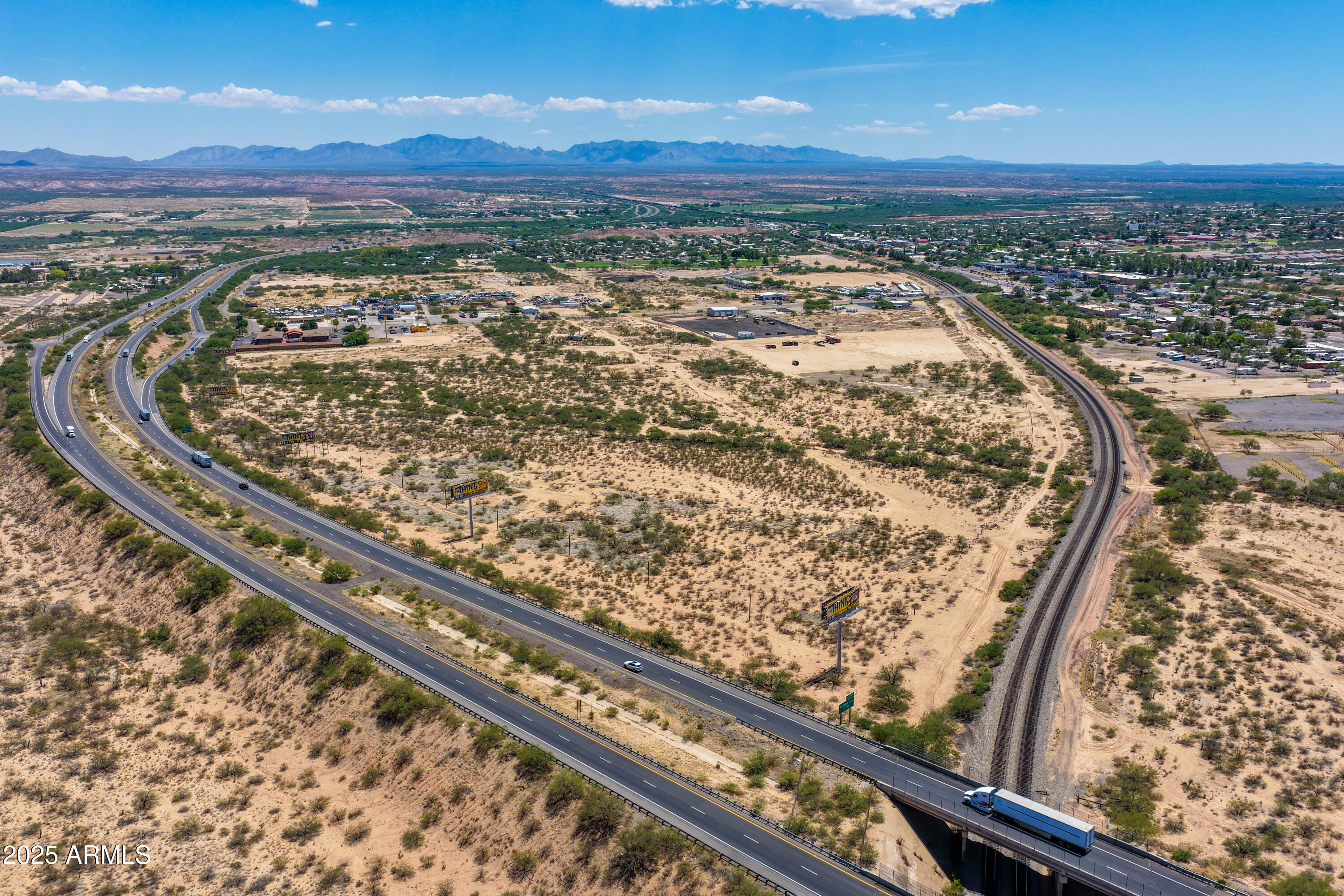 51.4 acres across 4 parcels in Benson, AZ. Prime location at I-10 & Ocotillo Rd with excellent access to I-10, SR-80, and SR-90. Surrounded by key demand drivers including Benson Municipal Airport, Tucson International Airport, Aluminum Dynamics, Tractor Supply, Safeway, and Dollar General. Nearby residential growth from Villages at Vigneto and Ocotillo Grande Ranches supports long-term industrial development potential. Note: Two 30-inch high-pressure cross-country gas pipelines traverse the center of the property. Billboards do not convey (2.26 acres reserved for billboard use). Easement map is available in the document section.
