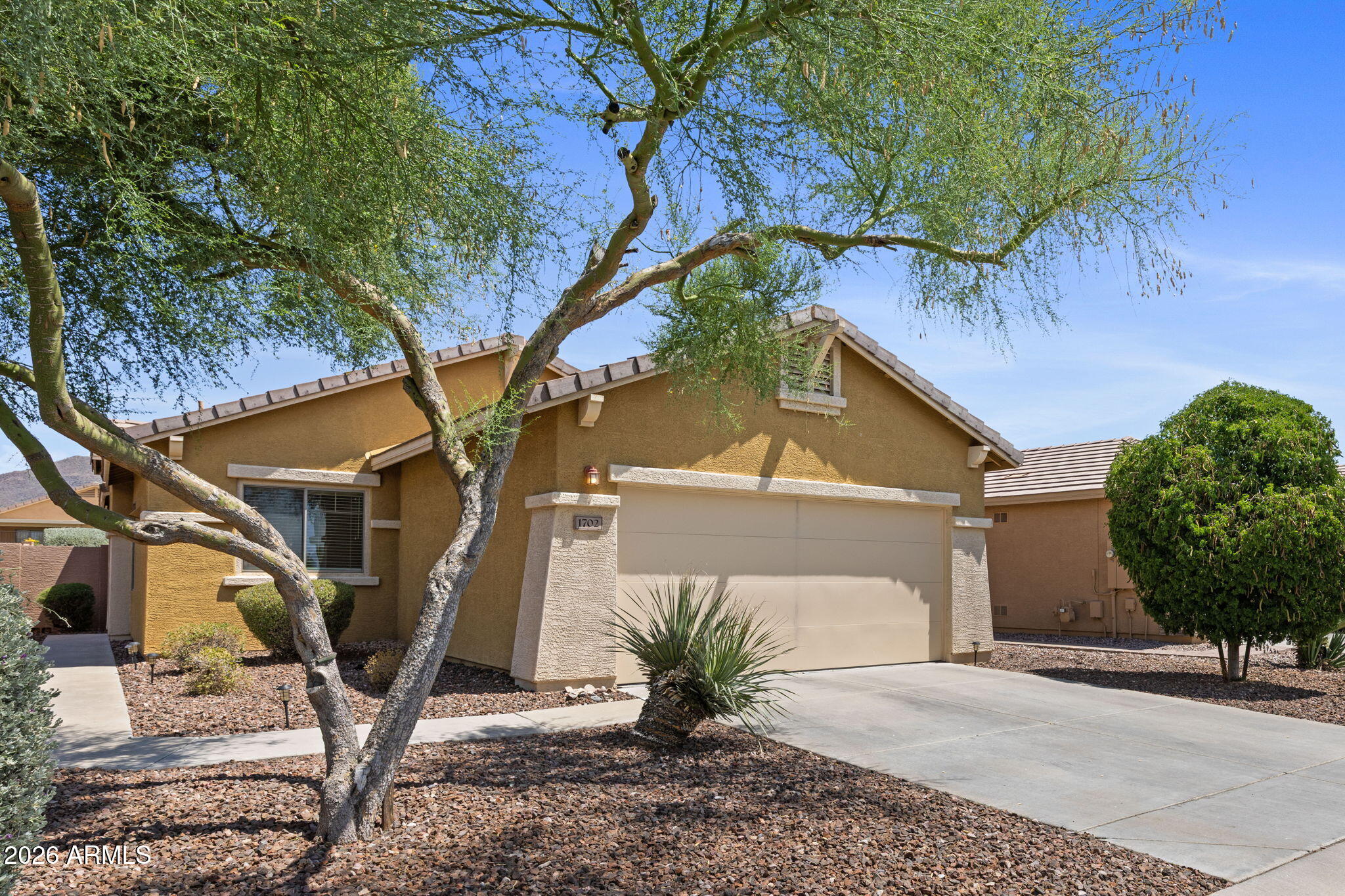 Welcome to 1702 W Owens Way in Anthem Country Club, a bright, low-maintenance home in one of Arizona's most desirable gated communities. Updated & popular Espino floorplan is open with abundant natural light, making the living & dining area inviting. Warm wood-look flooring, fresh white walls, & a stylish kitchen featuring soft green cabinetry, stainless appliances, & gold-tone accents. The thoughtful layout offers flexibility for guests, a home office, or everyday living. Enjoy AZ outdoor living with a covered patio, desert landscaping, & room to create your own backyard retreat on the wash lot with view fencing.  Plenty of privacy with no rear or front neighbors. A great opportunity to enjoy the ACC lifestyle in a manageable, move-in-friendly home. Many updates all within past 3 years.