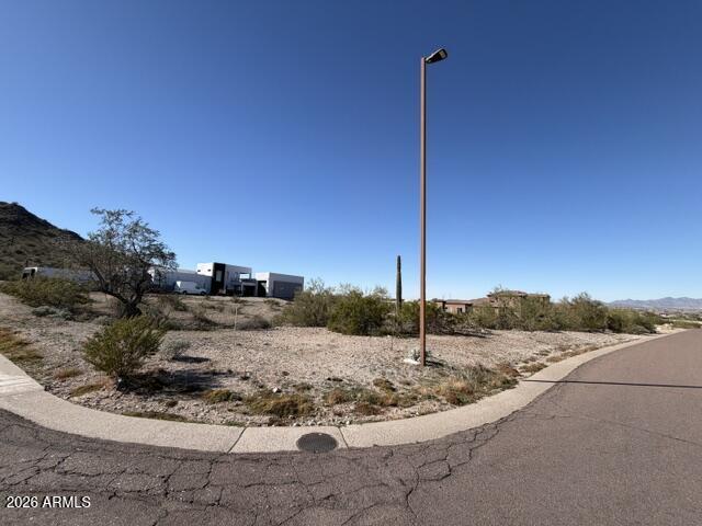 Don't miss this opportunity to own a beautiful 0.92-acre corner lot in the highly desirable Estrella Mountain Ranch master-planned community. Surrounded by stunning mountain views and located just minutes from the community golf course, this spacious homesite is the perfect place to build your custom dream home. City utilities are available at the road, making the building process even more convenient. Estrella Mountain Ranch offers an incredible lifestyle with lakes, parks, miles of hiking and biking trails, community pools, fitness centers, dining, shopping, and year-round events, all while providing a peaceful desert setting with easy access to everything you need.
