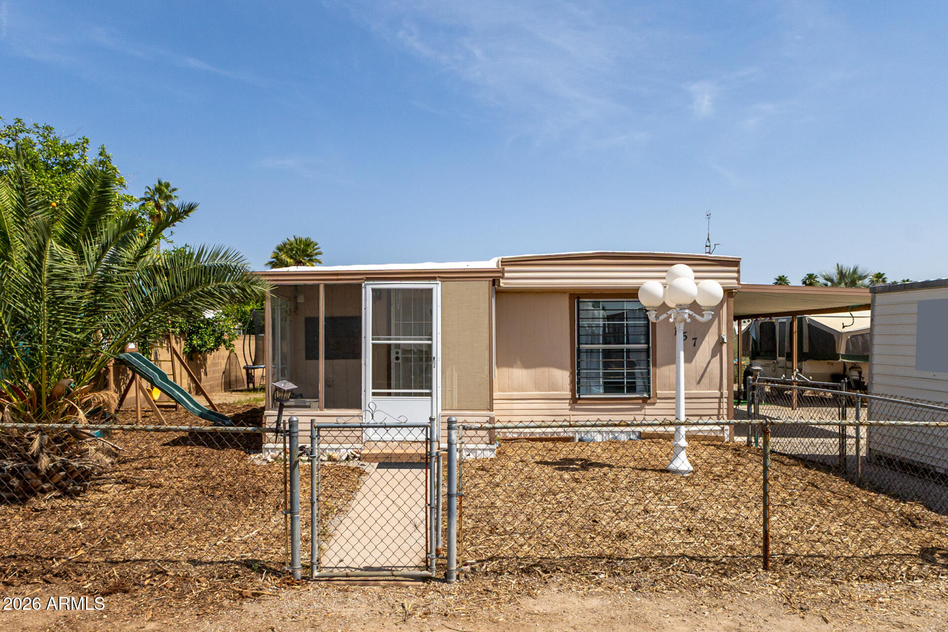 OWN THE LAND--NO HOA, NO LOT RENT & RV GATE! Enjoy the ultimate freedom of land ownership in this updated 2-bed + Den, 1.5-bath home. Situated on a private, fenced lot with a wide RV gate and plenty of parking, it's the perfect setup for your motorhome, trailers, and desert toys.
Inside, you'll love the huge, open great room--ideal for entertaining--complemented by a versatile den and hard flooring throughout. The full bathroom has been recently remodeled with modern finishes. Relax in the massive, enclosed Arizona Room or utilize the large added storage room for all your hobbies. Finding a move-in-ready home with an RV gate and private land at this price is rare. Say goodbye to restrictive rules and bring the toys!