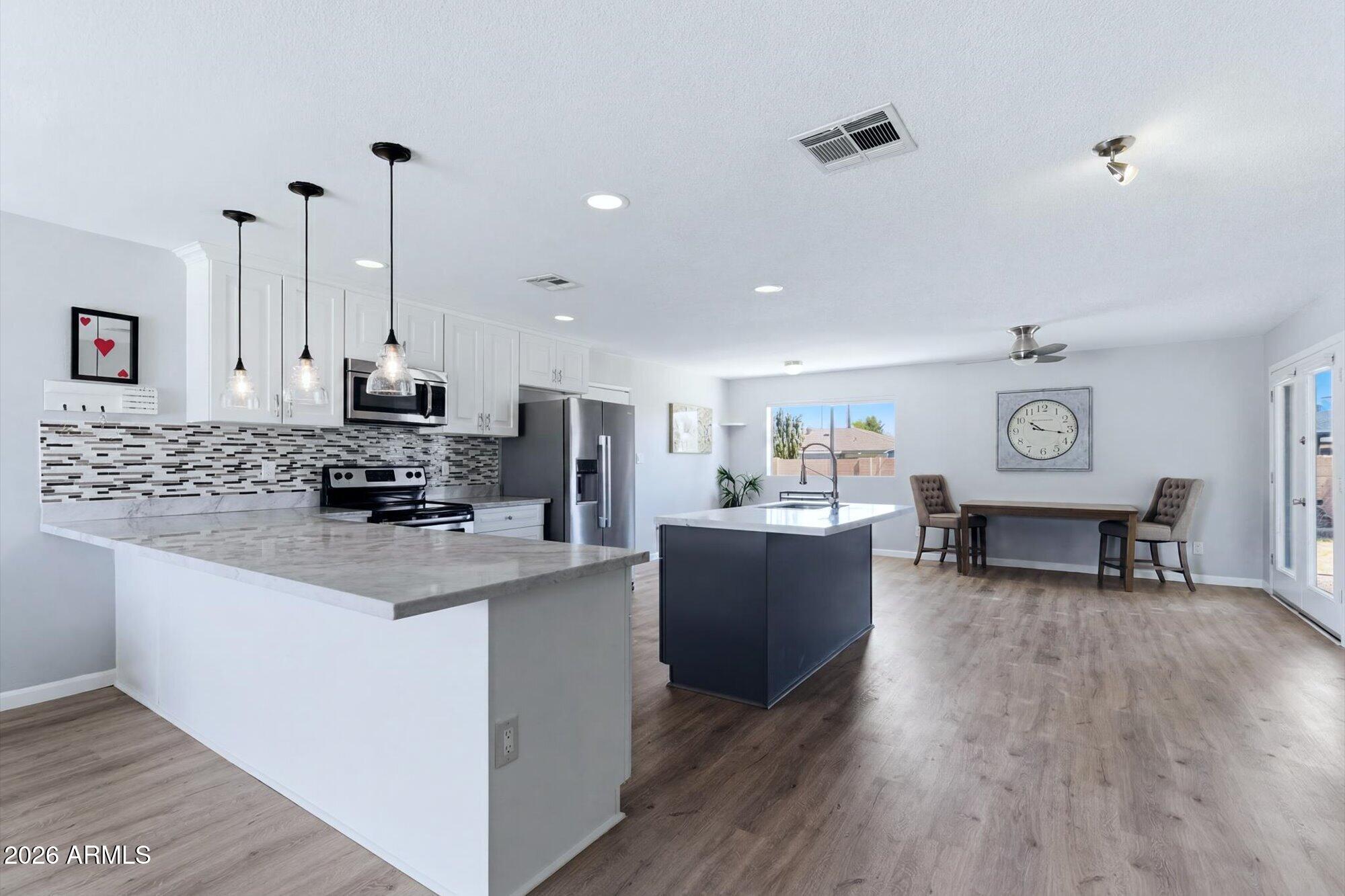Set on a quiet cul-de-sac, this updated single-level ranch home puts South Scottsdale within easy reach. Behind a blue door, an open great room joins living, dining & a kitchen island finished in stone counters, white cabinetry, a mosaic-tile backsplash & stainless steel. Luxury vinyl plank flows through the main living spaces, with carpet in the three bedrooms; the primary offers a walk-in closet & a tiled walk-in shower. A dedicated laundry & mud room sits inside, off the living area. The major systems are already done: roof/AC 2017, water heater 2018, flooring 2023, so ownership starts without a project list. 1-car Garage! Walk to El Dorado Park & the Greenbelt; reach Old Town, ASU, & Scottsdale Stadium in minutes. Block-fenced backyard, no HOA & a coveted North/South exposure.