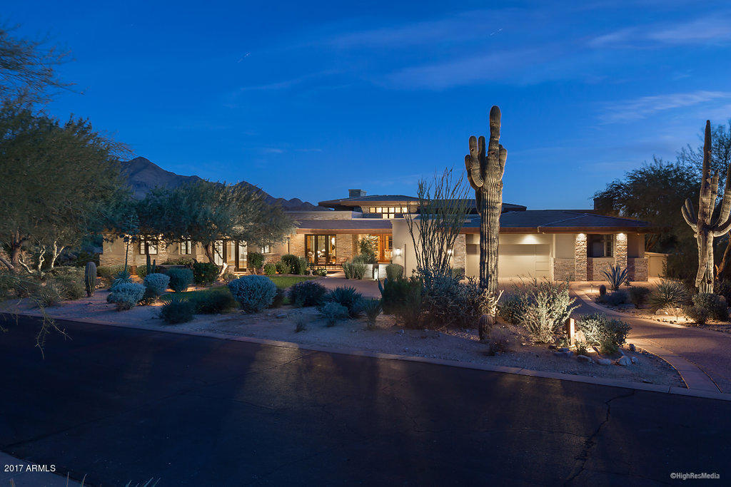 Gorgeous Views from this stunning golf course property built by Salcito Custom homes on one of the most desirable lots in the Country Club at DC Ranch.  This Desert Contemporary style home with over 630’ of golf course frontage and unobstructed views of the city lights and McDowell Mountains offers elegance and sophistication with high soaring ceilings, walls of glass to capture views, and generous outdoor living spaces.  The floor plan includes a large private master suite with exercise room, a guest wing with separate entrance that includes two bedrooms, two baths, plus sitting room with kitchenette including sink, microwave and refrigerator/freezer.  The backyard enjoys panoramic views of the golf course, mountains, and city below, large resort style pool and spas as well as a functional outdoor kitchen with built-in grill, refrigerator, sink, fireplace and banco.  The interior features include power window shades, Lutron lighting system, steam shower, whole house audio distribution, a climate controlled workshop and a temperature controlled wine cellar that holds 800 bottles.  Exterior features include three water features, rooftop deck with fireplace, eight total patios, misters, televisions and built-in heaters, automated sun screens and security cameras.