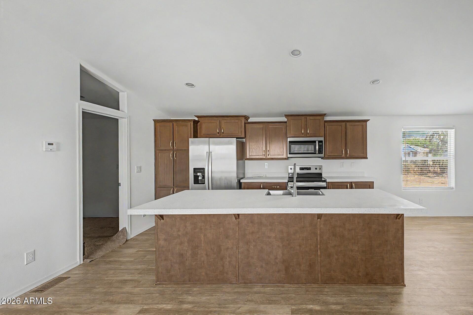 Beautiful brand-new 2026 manufactured home offering 4 bedrooms, 2 bathrooms, and 1,605 sq ft of bright, modern living space. The open-concept floor plan features a spacious living area, recessed lighting, vinyl flooring, and a stylish kitchen with an island, stainless steel appliances, and ample cabinet space. Both bathrooms showcase clean, contemporary finishes. Outside, enjoy more than an acre with plenty of room for parking, storage, or future outdoor ideas. Move-in ready and designed with low-maintenance living in mind, this property offers modern construction, fresh finishes, and generous indoor-outdoor space.
