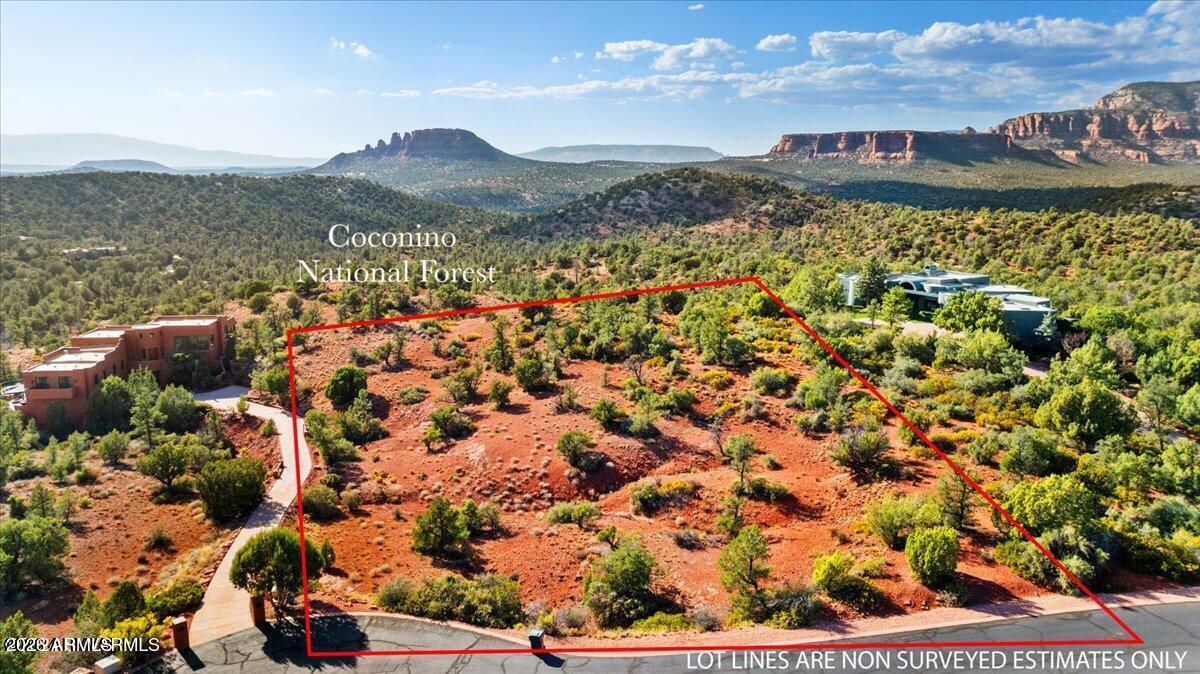 Opportunity to own a one of a kind beautiful , serene 2-acre lot in the highly sought-after gated community of North Slopes. This exceptional homesite offers truly breathtaking 360° panoramic views in every direction of Sedonas red rocks--sunrises, sunsets, and endless mountain vistas. Backing directly to the Coconino National Forest, you'll enjoy unmatched privacy and immediate access to miles of scenic hiking trails right out your back door. Whether you're looking to build your dream home or invest in a rare piece of Northern Arizona beauty, this property delivers peace, space, and unforgettable views from every angle. Utilities at property line. Recently paved road throughout the gated community.