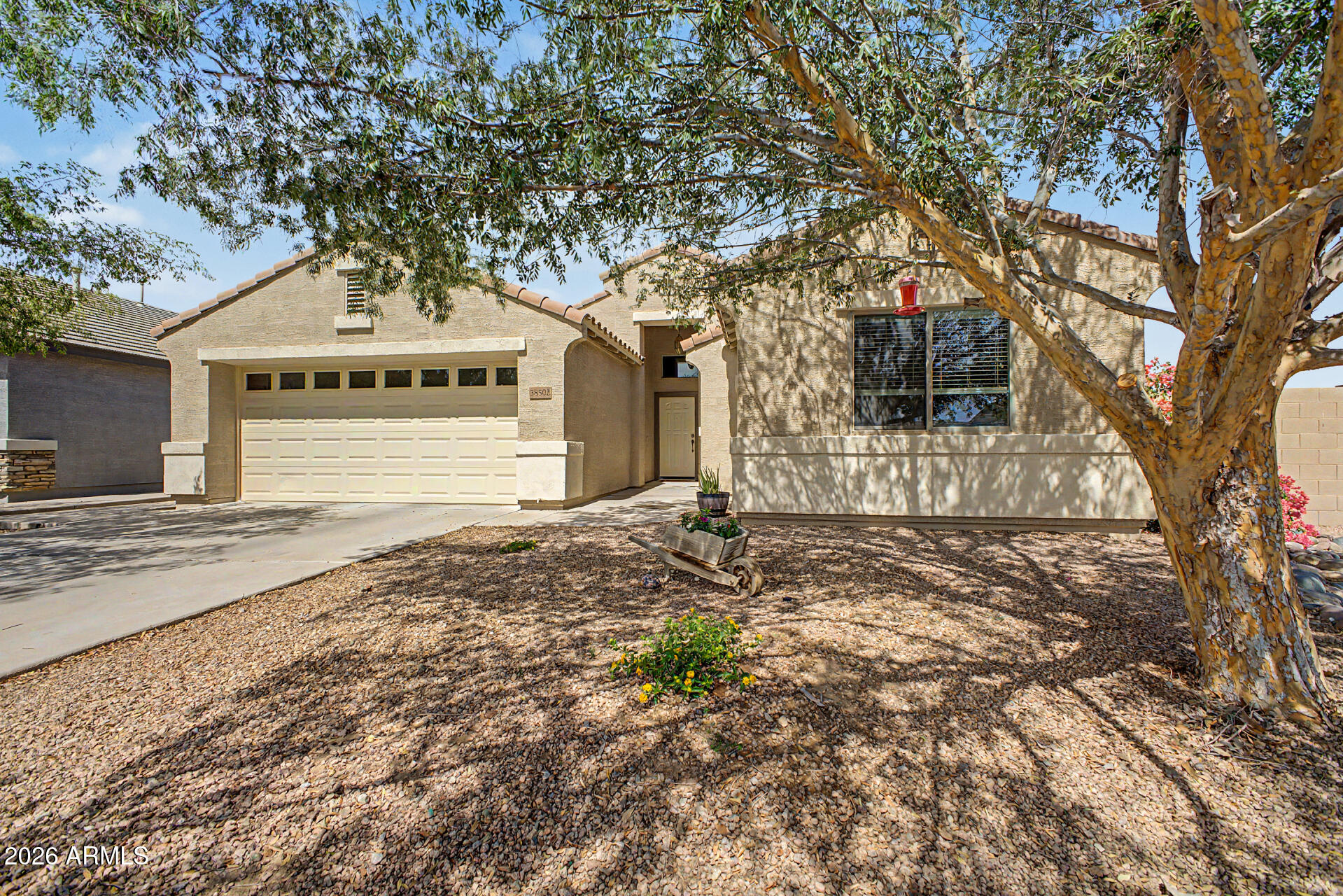 **THREE-BEDROOM FLOOR PLAN** - THIS IS IT--MOVE-IN-READY D.R. HORTON HAVEN: CORNER LOT.  PRIVATE CUL DE SAC NEXT TO ELLSWORTH ELEMENTARY.  EXTENDED GARAGE.  GORGEOUS LARGE LANDSCAPED PRIVATE YARD AND SUN ROOM!  3-BEDROOM FLOOR PLAN: Ready to enclose third Bedroom.  Meticulously maintained by these *Original Owners*, this wonderful home backs to Ellsworth Elementary School and is ready for a Pool!!  Why wait months for a new build, pay premium construction prices, and inherit the immediate, exhausting out-of-pocket expense of installing your own landscaping, window blinds and so much more? Skip the construction zones and step directly into 38502 N. Dawn Ct, a home with true heart, mature beauty, and absolute day-one completion. Nestled on a quiet, private cul-de-sac with (READ MORE) zero through-traffic, this gorgeous single-level, 3-bedroom-floorplan residence built by premier builder D.R. Horton sits on an expansive, premium 8,183-square-foot lot. It delivers the structural integrity that D.R. Horton is famous for, privacy, and generous space that modern, tight-lot developments simply cannot replicate.

The property delivers showstopping curb appeal right from the start, welcoming you with a landscaped front yard highlighted by a dramatic dry riverbed rock feature, vibrant blooming desert flora, and mature shade tree that casts beautiful canopy shadows across the property. A deep, recessed covered entryway framed by elegant double pillars leads you past a leaded-glass window accent to the front door.

The crown jewel of this property is the fully enclosed Arizona sunroom/screened porch. Featuring beautiful Spanish-style tile flooring and wrap-around screens, this bonus space serves as a retreat for outdoor dining, a morning exercise studio, or relaxing in a bug-free environment. Step through the sunroom doors into a private backyard paradise that leaves a dirt lot to shame. You are greeted by a meticulously maintained, lush green grass lawn bordered by professional brick curbing and mature, flourishing shade trees. Complete with vibrant bougainvillea bushes and a separate paved grilling area, this yard offers plenty of open ground to design a custom resort pool if desired.

Inside, the open-concept layout feels instantly warm, grand, and welcoming, lifted by soaring vaulted ceilings. Beautiful, durable wood-look tile flooring stretches seamlessly through the high-traffic areas, dining space, and kitchen. The chef's kitchen is a functional masterpiece, boasting a large central breakfast island, rich wood cabinetry, a built-in microwave, a gas range, and a premium stainless-steel French-door refrigerator. Storage is a dream, anchored by the walk-in pantry with floor-to-ceiling wrapped shelving. The kitchen flows effortlessly into a dedicated dining space flanked by custom architectural accent windows, looking directly out to the family room.

A standout feature of this layout is its ultimate flexibility. D.R. Horton originally designed this floor plan as a flexible 3-bedroom option. While the current owner chose to keep that space open as a light-filled home office and tech center, the space can be effortlessly enclosed with a standard wall and door to establish hte private, traditional third bedroom that D.R. Horton provided for in the floor plan.

The primary suite serves as a sprawling personal sanctuary, elevated by its own vaulted ceilings and featuring ample space for a king-sized bedroom set alongside a personal desk setup. The private en-suite bathroom is fully loaded for relaxation, offering a deep soaking tub, a separate walk-in shower, an extra-long dual-sink vanity with bright theater lighting, and a massive walk-in closet. Across the home, the secondary bedroom offers excellent privacy for guests or family, situated steps from the second pristine full bathroom.
Rounding out this highly functional home is a large open separate laundry room packed with lower cabinetry, a long folding counter, and overhead storage. For the hobbyist, mechanic, or organizer, the clean 520-square-foot, 2-car attached garage has been upgraded into an immaculate workshop, featuring extensive custom shelving and heavy-duty pegboard tool storage.

An Unbeatable Location: This prime lot sits directly in front of the highly regarded J.O. Combs Unified School District campus right behind it--making school mornings completely stress-free. Beyond the safety of your cul-de-sac, you are just a short drive from Queen Creek's booming retail developments, including the new Vineyard Town Center (featuring Super Target, Sprouts, premier dining, and coffee shops) and the spectacular new Frontier Family Park.

Don't settle for an unfinished construction zone! Come fall in love with a seasoned home that has true soul, total functionality, and absolutely zero remaining projects!