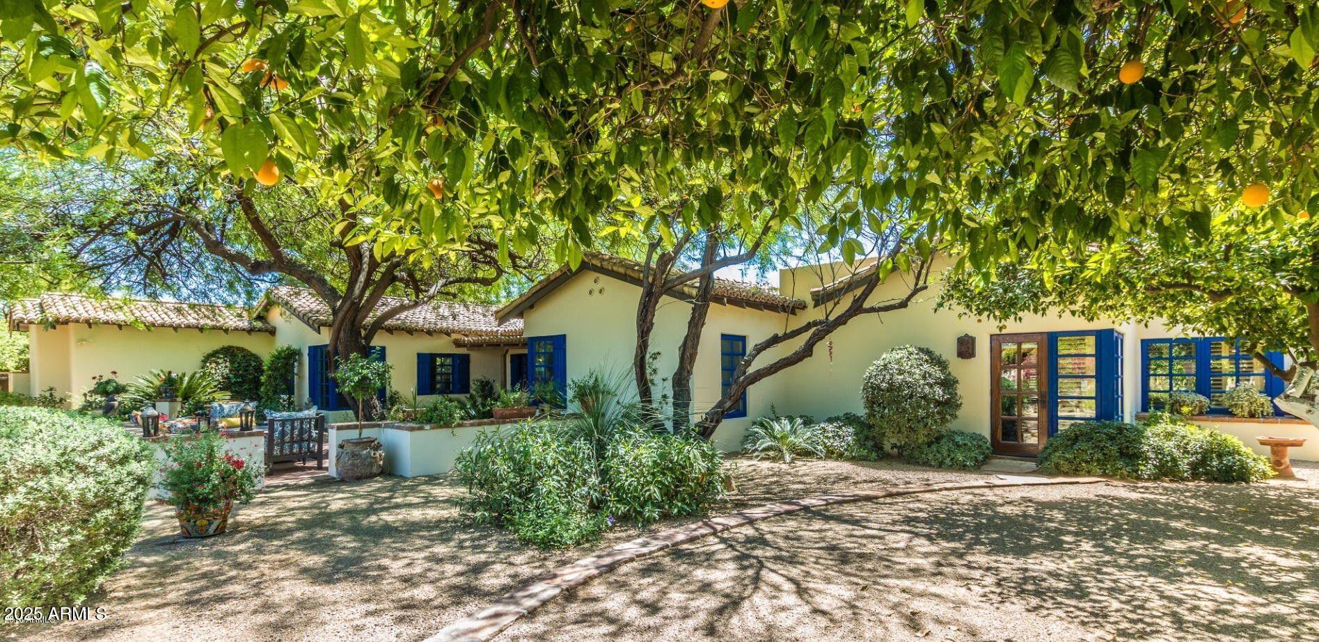 Stunning & historic 1940 adobe estate/compound, lovingly expanded & updated over the years while maintaining its original old world charm.  This private compound sits on a spectacularly landscaped 3/4 acre lot in Arcadia with resort-like pool, patios, fountains, lush grass & shady trees. The 4600 s.f. main house features soaring hand hewn cross beamed ceilings in its huge living room & primary bedroom suite.  Wonderful cook's kitchen w/ top of the line appliances, 3 fireplaces , 2 offices plus 2 other bedrooms.  Authentic wine cellar, plaster walls & custom iron & tilework add to its charm.  There is a 630 s.f. detached guest casita plus an adjoining 510 s.f. flex/office/family room w/soaring ceilings & stately fireplace.  Don't miss this warm & wonderful estate!