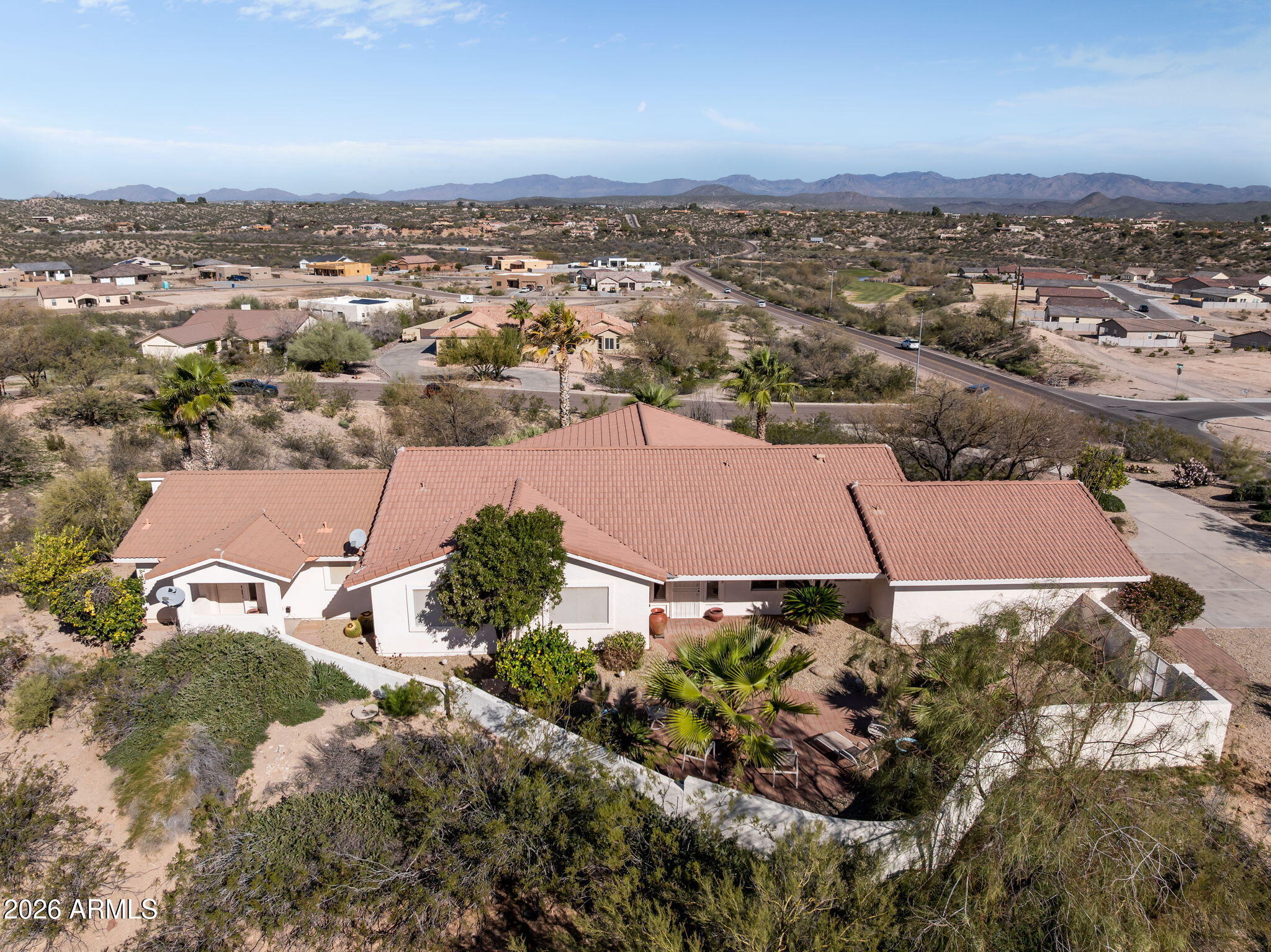 Discover tranquil hillside living in this beautifully maintained 2-bedroom, 3-bath home with an attached guest suite, den, and 2-car garage. Designed for both comfort and flexibility, the open-concept floor plan features two dining areas, a breakfast bar/island, a spacious living room, and a separate den—ideal for a home office or media space.

The primary suite is a true retreat, offering dual sinks, a soaking tub, a separate shower, and a private water closet. Thoughtfully appointed throughout, this immaculate home reflects pride of ownership at every turn.

Enjoy stunning mountain views from the north-facing, fenced backyard, where abundant natural light enhances the serene outdoor setting. The elevated hillside location provides privacy and peaceful surroundings, while still offering convenient access to community amenities. Completing the property are a charming walled front courtyard and a private backyard patio, perfect for relaxing or entertaining.