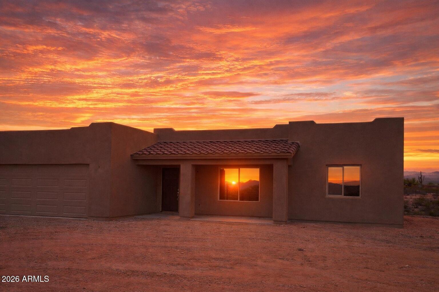 Welcome to your custom-built desert sanctuary, where the Arizona horizon stretches endlessly and equestrian dreams gallop into reality. No HOA. This meticulously crafted three-bedroom, two-bathroom residence has 1,428 square feet of thoughtfully designed living space, crowned by gleaming granite countertops and polished stainless appliances that transform everyday cooking into a culinary celebration. But the real magic unfolds beyond the front door. The privacy fence gives you the feeling of seclusion, while still a part a unique roping community. A sprawling 140 by 250 roping arena beckons seasoned riders and weekend cowboys alike, while the generous lot provides ample room for barns or additional corrals for the horses. The pull-through driveway accommodates large trailers with ease. Dedicated RV plugs ensure your adventurous spirit never stays parked for long. The surrounding Wittmann neighborhood offers proximity to numerous additional arenas, creating a vibrant equestrian community that feels both welcoming and wonderfully untamed. Lake Pleasant and countless recreational destinations lie within effortless reach, while the charming towns of Surprise and Wickenburg sit just fifteen and twenty minutes away, respectively. Quality construction meets boundless possibility on this exceptional property. Schedule your private showing before someone else saddles up and rides away with it.