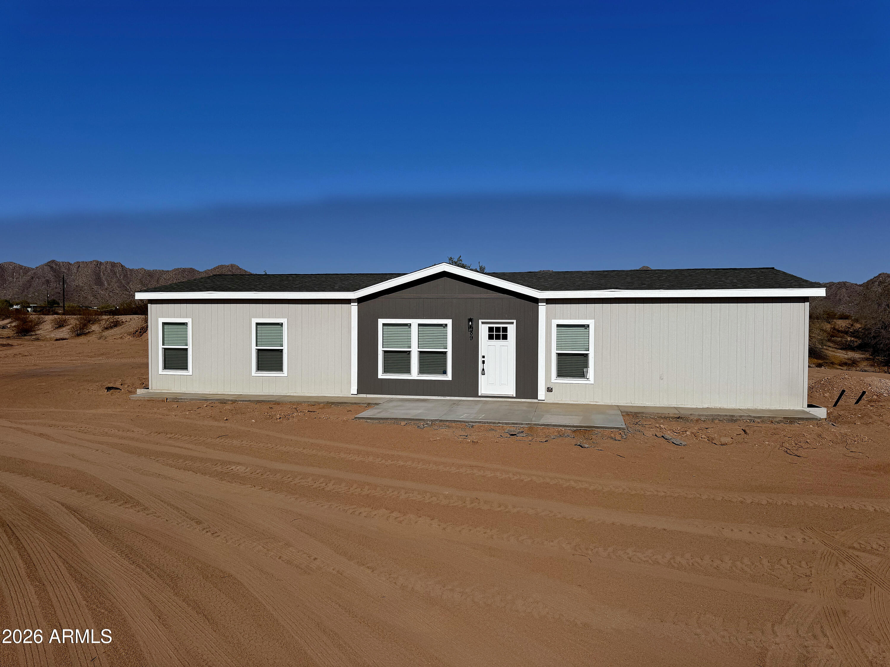Brand new. Wide open. All yours. This 2026 ENERGY-EFFICIENT 4-bedroom, 2-bath home sits on nearly 2 ACRES with INCREDIBLE MOUNTAIN VIEWS -- on a PAVED ROAD, NO HOA, no compromises. Inside: 1,600 SQ FT of OPEN living with 9-foot ceilings, a gourmet kitchen with large island, STAINLESS STEEL APPLIANCES, white hardwood cabinets and black laminate countertops and hardware, and a separate dining room with a sliding glass door to the rear patio. The MASTER SUITE features double sinks and a walk-in closet. WASHER AND DRYER INCLUDED. Smart thermostat, faux wood blinds throughout, concrete front and back patios, and a NEW SHARED WELL and NEW SEPTIC. ADDITIONAL HOMES AVAILABLE.