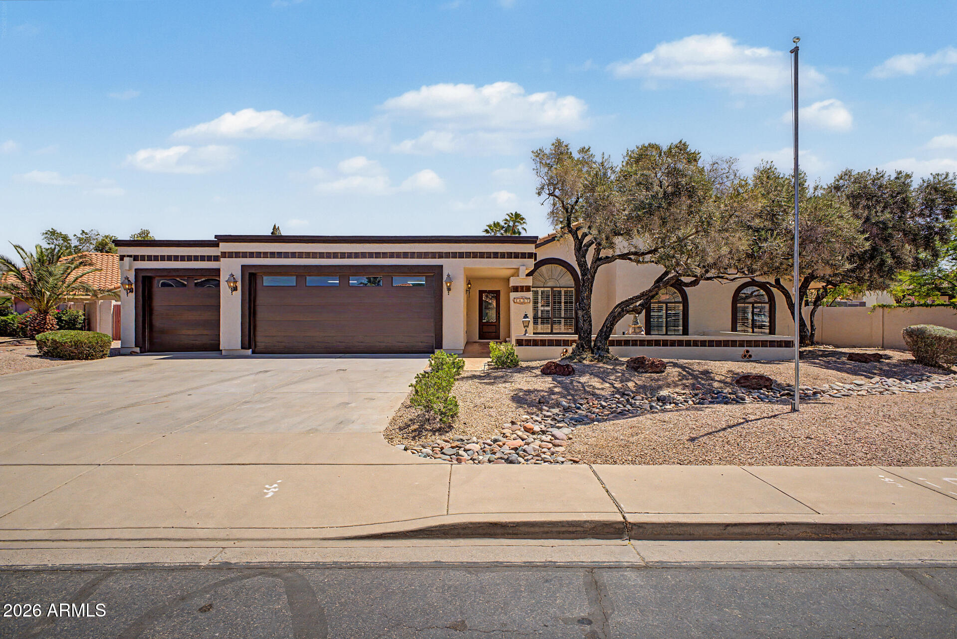 Fully renovated, this stunning North Mesa home delivers the rare combination of modern upgrades, generous space, and NO HOA--situated on a 1/3-acre lot in a highly convenient location just minutes from the freeway, major shopping, dining, and Cactus League spring training facilities. Built with durable 2x6 construction and designed with an open-concept floor plan, the home welcomes you with vaulted ceilings, abundant natural light, and a seamless flow between living, dining, and kitchen spaces. A custom-tiled wood-burning fireplace anchors the main living area, creating a warm yet refined focal point.
At the heart of the home is a truly impressive gourmet kitchen--expanded and redesigned for both everyday living and entertaining. It features a massive 12-foot island with designer quartz countertops, white shaker cabinetry with 42" uppers, soft-close doors and drawers, a stylish backsplash, and a deep Kohler stainless steel single-basin sink with a commercial-style faucet. High-end Frigidaire stainless steel appliances include a 5-burner convection oven with air fry option, upgraded dishwasher, over-range microwave, and counter-depth side-by-side refrigerator.
Throughout the home, you'll find new porcelain wood-look plank flooring, upgraded carpeting with premium pad, fresh interior paint, modern LED lighting and recessed fixtures, new ceiling fans, updated plumbing fixtures, new door hardware, 4.25" baseboards, and updated switches and outlets--creating a cohesive, move-in-ready finish from top to bottom.
The oversized primary suite offers exceptional space and comfort, with a spa-inspired bathroom featuring a large jetted tub, designer tile shower, new valves and trims, updated vanity lighting and fixtures, and its own dedicated water heater. Secondary bathrooms have also been fully upgraded with designer finishes.
Additional highlights include a dual-zone HVAC system (2022) for efficient climate control, newer roof underlayment (per previous seller), and a spacious laundry room with built-in cabinetry, shelving, and ironing board.
The exterior is just as impressive. The expansive backyard is designed for low maintenance and maximum enjoyment, featuring high-end turf landscaping and a massive 12' x 50' covered patio--perfect for entertaining or relaxing year-round. The oversized lot also includes a ~10' RV gate and plenty of room for additional storage, toys, or customization.
Car enthusiasts and those needing extra space will appreciate the oversized 3-car garage, offering exceptional depth and width, along with built-in cabinetry, a freshly painted interior, and an epoxy-coated floor. The extra-wide and deep driveway provides even more parking flexibility.
This is a rare opportunity to own a fully renovated, turn-key home on a large lot in North Mesa with no HOA, premium upgrades throughout, and a prime location close to everything.
