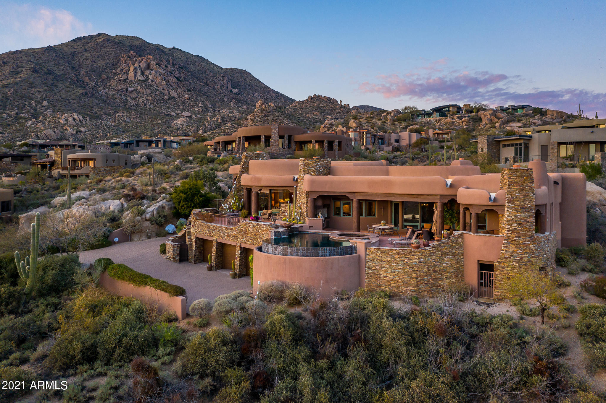 Exquisite Mediterranean Estate home on a promontory in Sunset Canyon... set into beautiful rock outcroppings in this quaint village  boasting some of Desert Mountain's highest elevations... providing the finest of Arizona sunsets and twinkling city lights. Every attention to detail was given to the design and execution of both the exterior and interiors. Stunning Great Room with impressive hearth and carved beams, exiting to outdoor living  patio. Gourmet kitchen and large adjoining hearth room open to garden and view patios. Master wing with office plus  2 additional king ensuites in the main home...fabulous 2 room casita with living, kitchen, king bedroom and hearth patio.  Posh home theater; 9 fireplaces in all.  The furniture is available as well as the adjacent lower Lot #15.
