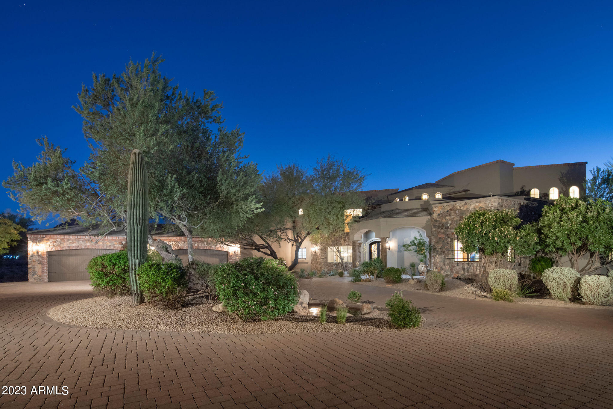 Redesigned in 2020 for primarily single-level living, this fully furnished estate features light-filled interiors and seamless indoor-outdoor flow with resort-style outdoor spaces, pool, spa, and sweeping valley and city-light views. See document tab for updates. The main level blends open gathering areas with private rooms for work, media, and relaxation, while a secondary primary suite, den, and game room upstairs offer flexibility for guests or multi generational living. Set on 3.8 acres within a gated community and bordered to the north by 11 acres of HOA-owned open land, the property offers exceptional privacy and scale. A private one-bedroom casita, detached 1,815-sf auxiliary building, and 10-car garage complete the estate embracing expansive desert valley views. The kitchen blends refined design with high performance, anchored by a curated appliance suite and a 200-bottle, glass-walled, temperature-controlled wine cellar that becomes part of the architecture. A linear gas fireplace wrapped in natural stone adds a sculptural focal point, elevating both everyday living and evening entertaining. Designed for hosting, the media room features custom cabinetry and a sleek bar topped with a waterfall quartzite countertop that invites conversation. Glass sliders open directly to the infinity-edge pool and spa, creating a seamless indoor-outdoor connection. Two dedicated offices or dens further support today's work-from-home lifestyle and multigenerational flexibility. The residence offers a total of six ensuite bedrooms, with a seventh flexible-use room discreetly positioned beyond the media room, ideal as a guest suite, wellness room, or private retreat.
Fully furnished and ready to enjoy, this estate embraces the views and lifestyle that define North Scottsdale.