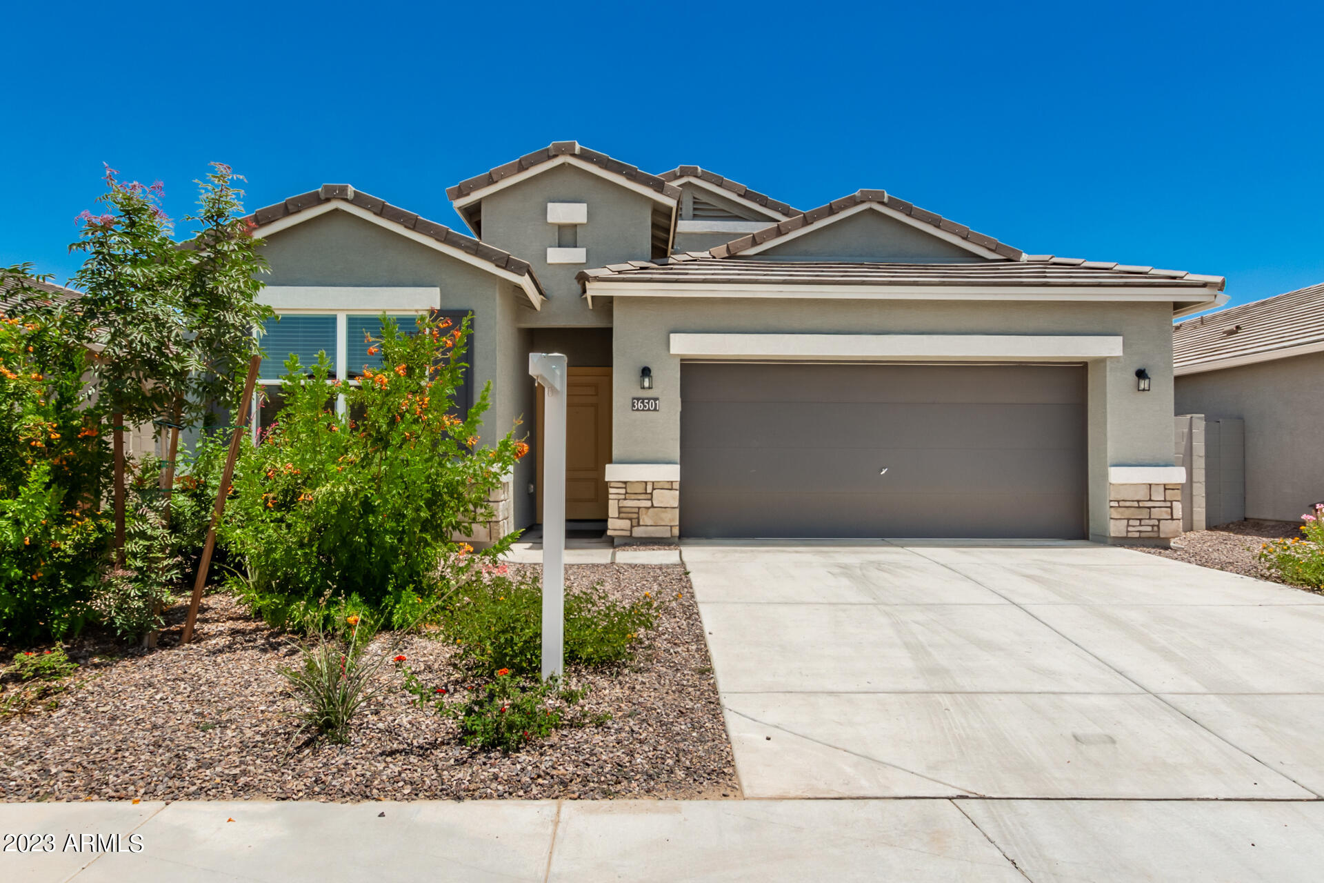 Built in 2022 and exceptionally well maintained, this nearly new home features the highly sought-after Palo Verde floor plan with an open-concept kitchen and great room designed for comfortable everyday living and entertaining. The chef-inspired kitchen has quartz countertops, a spacious center island with seating for four, and plenty of workspace. Stylish wood-look tile flooring flows throughout the main living areas, while the bedrooms offer the comfort of plush carpeting.

The spacious primary retreat features dual sinks, a walk-in shower, and generous closet space. Additional highlights include 2-inch faux wood blinds throughout, faux grass and pavers in the backyard.