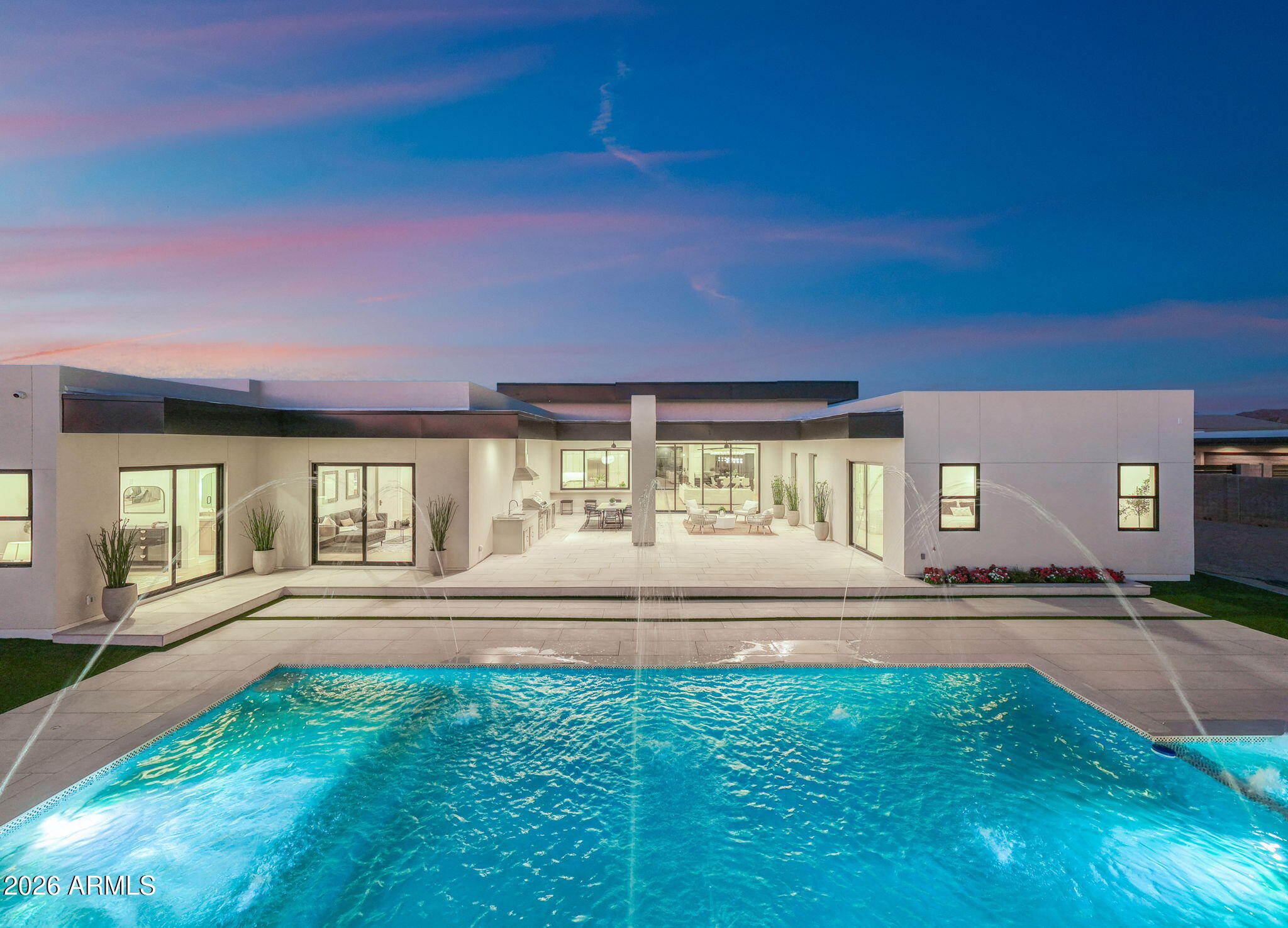 Beyond the gates of Equestrian Estates stands a modern masterpiece where timeless architecture and resort-inspired living converge. Set on a private 1.1-acre homesite, soaring 13-foot ceilings, walls of glass, and designer finishes define this extraordinary custom estate. A showpiece chef's kitchen is complemented by a concealed prep kitchen hidden behind custom cabinetry. The backyard unfolds as a private resort featuring a pool, spa, Baja shelf, water features, outdoor kitchen, and expansive covered patio. The spa-inspired owner's retreat, detached guest casita, executive office, hidden bonus room, Thermador appliances, four-car garage, horse privileges, mountain views, and direct gated access to Casteel High School complete this exceptional residence.
