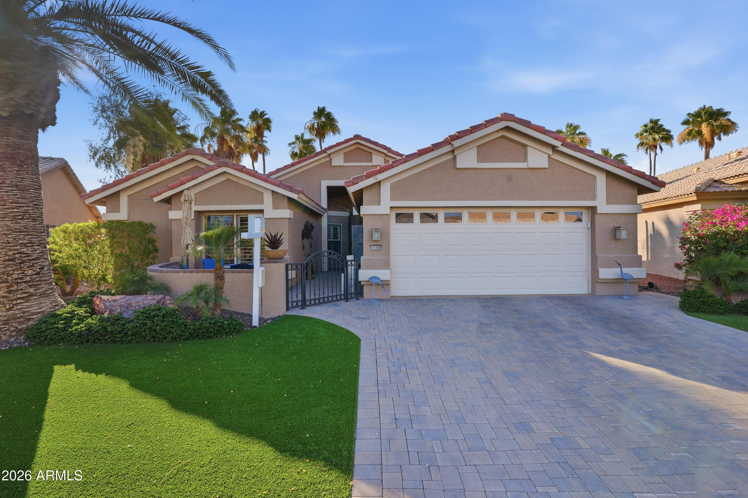 The home is on a golf course lot with a view of the Eagles Nest 7th fairway along with an amazing lake view!  This expanded Heritage open floor plan has 2 bedrooms, 2 bathrooms and a den/office.  The kitchen has granite countertops, stainless steel appliances, an abundance of cabinets and a center island with breakfast bar.  Principal bedroom is an ensuite with dual vanities and grab bars in the shower.  Home has a gated courtyard, 2-car garage with an epoxy floor with room for a golf cart, front yard is beautifully landscaped with turf, and backyard features a covered patio with misting system. Furniture and golf cart are available for sale.  Don't miss this spectacular property! PebbleCreek offers many amenities: Three 18 hole golf courses, 36 pickleball courts, tennis courts, bocce ball, two clubhouses, two fitness centers, indoor/outdoor pools, a 330-seat theater, two restaurants and over 100 clubs/organizations.