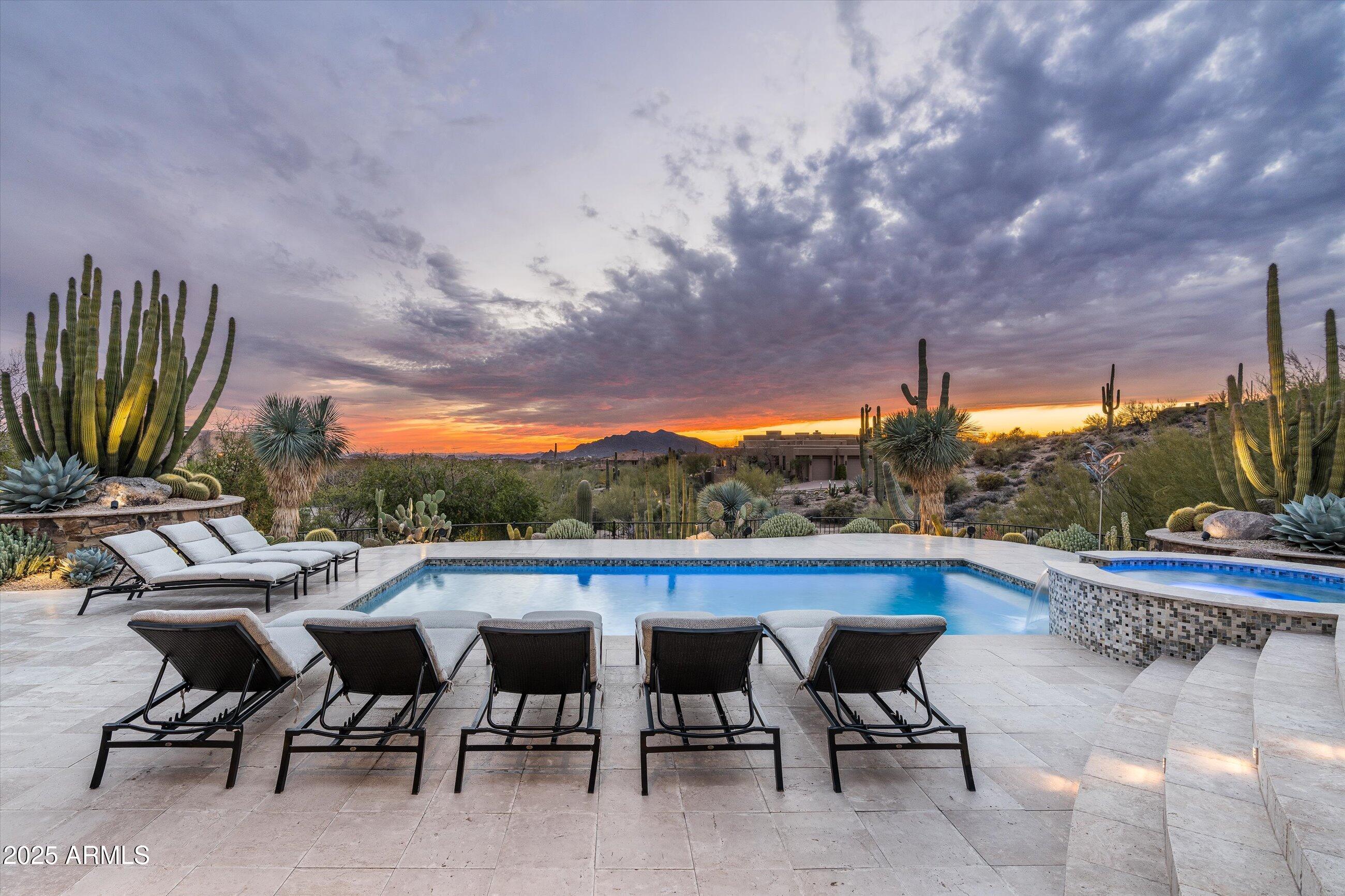 Featured in Luxe Magazine and beautifully renovated by Turner Martin Design, this Desert Mountain home is a true masterpiece.
Offering the perfect open floor plan, this home is exactly what today's buyers are searching for. The split layout includes four spacious bedrooms, each with its own ensuite bath, plus a study with an adjacent full bath for added convenience.

Designed for effortless indoor-outdoor living, this home is an entertainer's paradise. The large, stone-floored patio features a cozy outdoor family room, a pristine pool and spa, a stylish pool bath with an outdoor shower, a custom fire pit, a putting green, and a BBQ area complete with a sink, refrigerator, and ice bin.

Located in a rare lower village at Desert Mountain, this home offers stunning views of the valley city lights and the majestic mountains beyond. Enjoy spectacular sunsets from this one-of-a-kind setting.

Golf membership is available from the seller.  Home is being offered turn key with some minor exceptions.