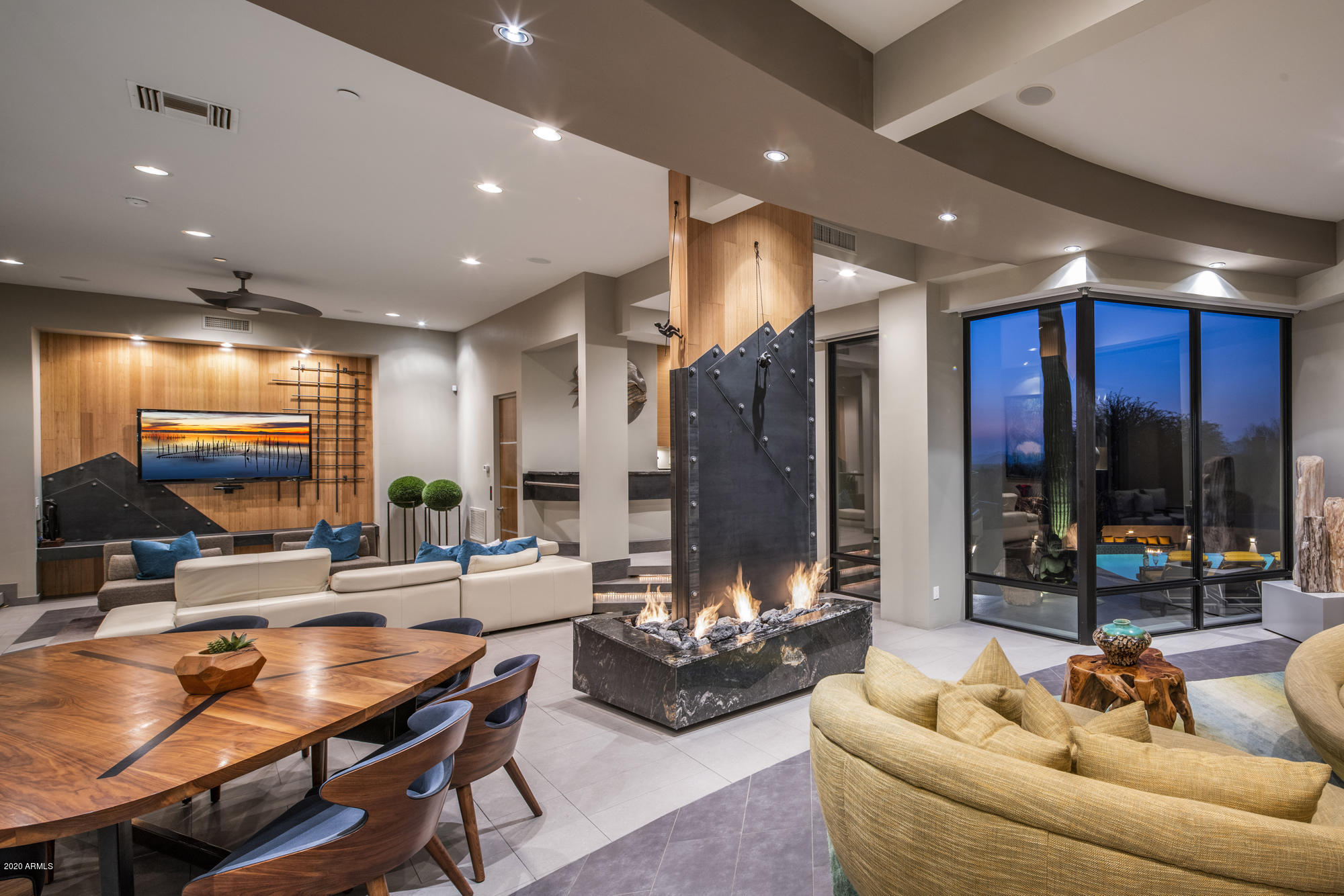 An extraordinary property tailored to perfection for contemporary living. Designed to flow over two levels, the entire home emanates sleek linear lines and large geometric volume, resulting in vast living and ample accommodation for friends, family and guests. Favorably located within the gated community of Pinnacle Canyon and drenched in North Scottsdale views, it's more than just a home, it's a work of art. 
Catering to those looking to live, work and play in an extraordinary space, the residence offers over 8400 SF of spaciousness. The kitchen is equipped to the highest standards with sleek cabinetry and top-of-the-line appliances that will satisfy the most demanding epicure. Impressive entertaining includes theatre room, multiple lounge areas and entire lower level dedicated to relaxation. Thoughtfully appointed within a spectacular backdrop of privileged views, the home is a showpiece of glamour and contemporary sophistication. Complemented with multiple living and dining areas that strike the perfect balance between entertaining and privacy, the superb attention to details appeal to the most discriminate buyer.
The sprawling outdoor space is a magnet for family fun, the perfect spot for gathering with friends, or an evening of quiet conversation. Enjoy the luxury and scale of a five-star hotel while watching the night skies sparkle. Tailored to indulgent comfort with an unparalleled capacity to entertain  a true feast for the eyes. Cosmopolitan living and a coveted address.