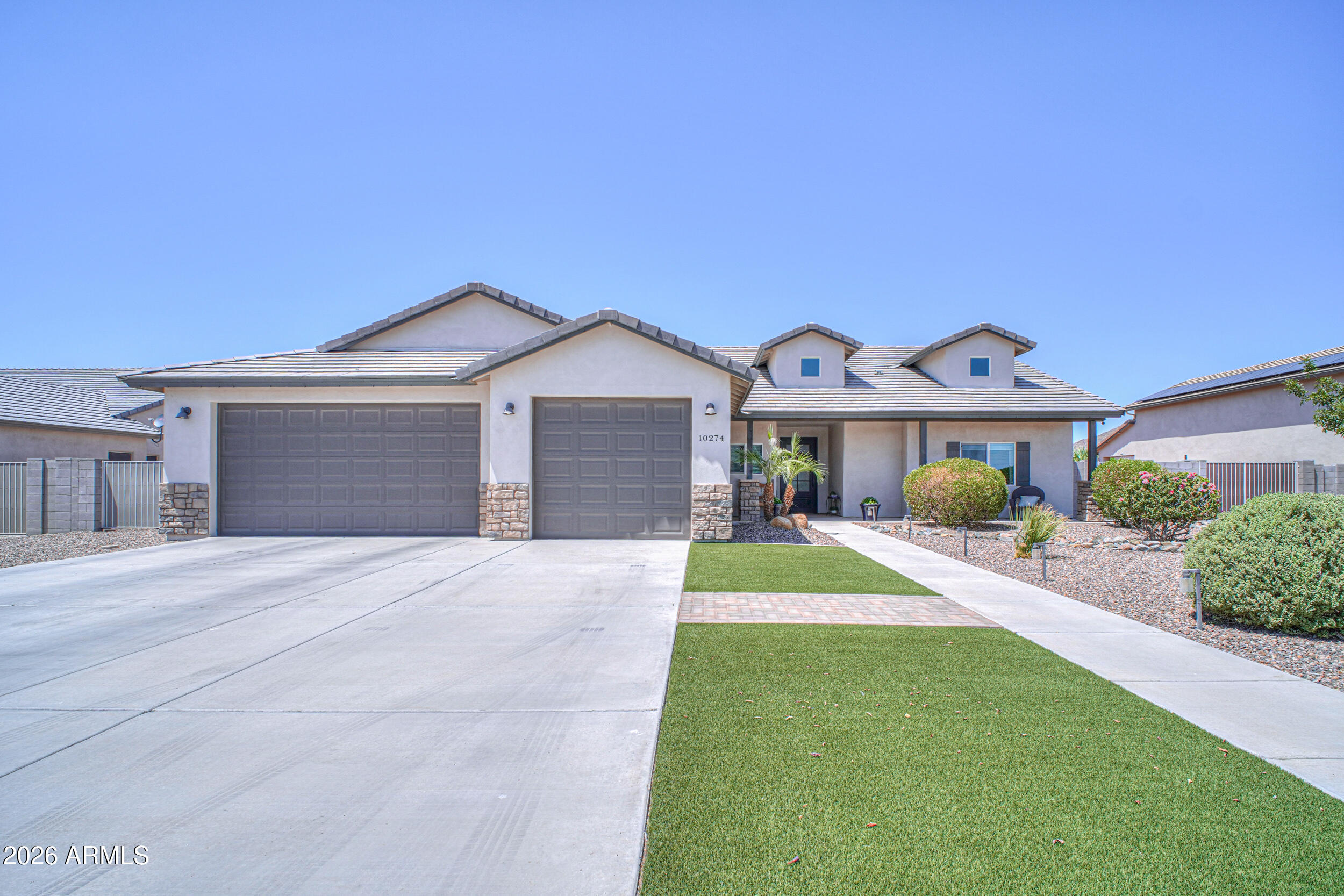 Welcome to Chaparral Estates, where modern farmhouse design meets spacious Arizona living! This beautifully upgraded 3-bedroom, 2-bath home offers 2,032 square feet of thoughtfully designed living space on an approximately ½-acre lot.

From the moment you arrive, you'll be impressed by the inviting curb appeal, oversized 3-car garage, and elegant solid iron and glass front door. Inside, the open-concept split floor plan showcases soaring vaulted ceilings, abundant natural light, and wood-look ceramic tile flooring throughout.

The stunning kitchen is designed for both everyday living and entertaining, featuring sparkling white quartz countertops, white maple cabinetry, a stylish tile backsplash, stainless steel appliances, oil-rubbed bronze hardware, a spacious walk-in pantry, and an oversized island with breakfast bar seating. The adjacent dining area and expansive great room create the perfect gathering space for family and friends.

The private owner's suite is a true retreat, offering direct access to the backyard and a spa-inspired ensuite featuring a double vanity, relaxing garden tub, and a beautifully designed walk-in shower with floor-to-ceiling tile, pebble stone flooring, and glass enclosure. The guest bathroom also features dual sinks and a fully tiled shower with glass doors.

Step outside to enjoy your own backyard oasis. A large covered patio overlooks the beautifully landscaped yard complete with lush artificial turf, mature landscaping, and a charming pergola--perfect for outdoor dining, entertaining, or simply relaxing under the Arizona sky. With approximately ½ acre, there's plenty of room to add a pool, workshop, RV garage, or create the backyard you've always envisioned.

Offering timeless finishes, quality craftsmanship, generous indoor and outdoor living spaces, and located in the highly desirable Chaparral Estates, this move-in-ready home truly has it all.

Don't miss your opportunity to own this exceptional property--schedule your private showing today!