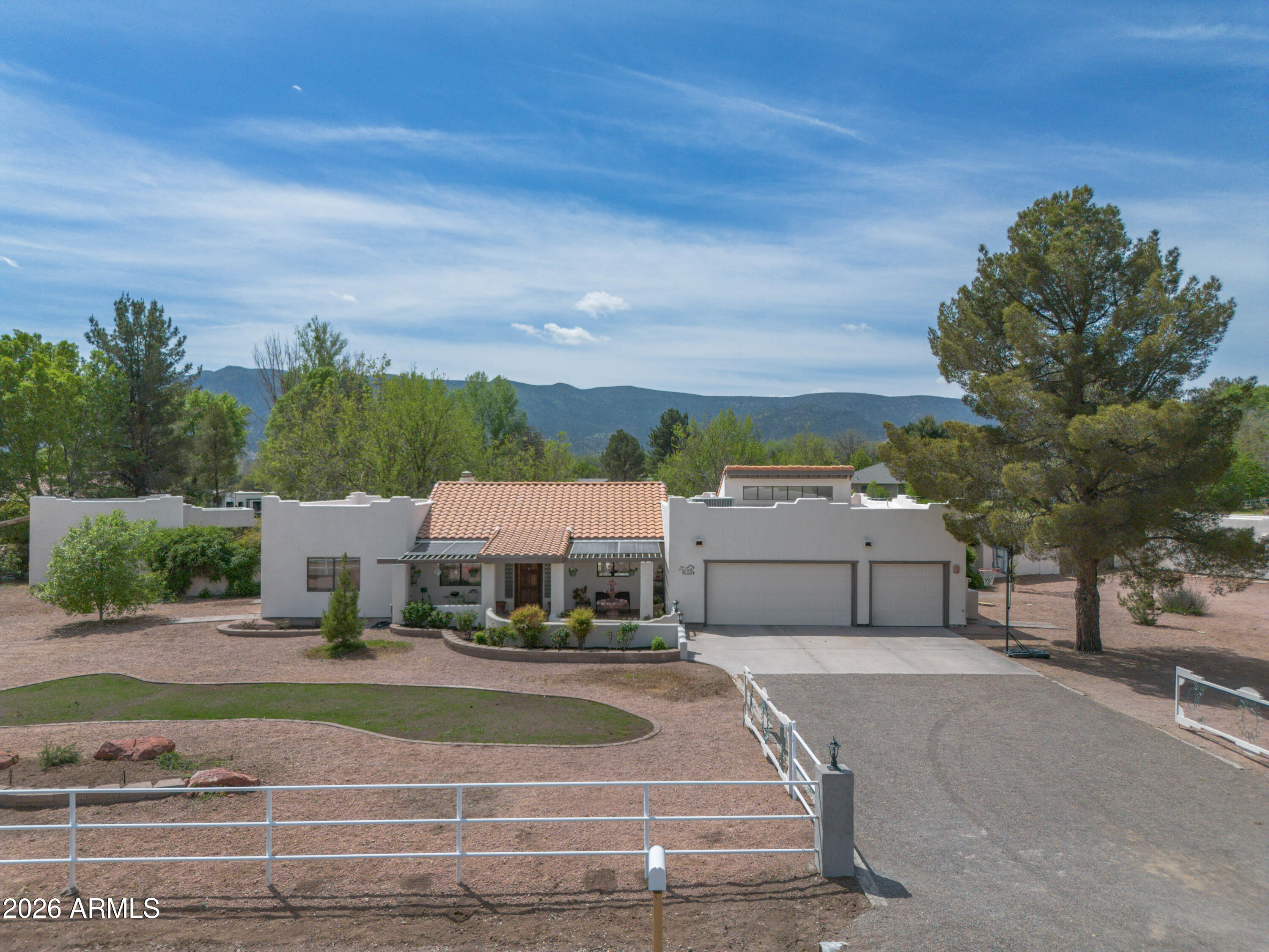 This location is one of the finest in Camp Verde with luxurious green irrigated pastures, fine homes, big lots with wide open panoramic views.  And just 5 minutes away are medical center, grocery, restaurants, vet, drug stores and more.  A wonderful main home with 2100 SF and 3c garage and spacious 600 SF guest house.  Also you'll enjoy a 225 sf studio/workshop and 2 stall barn/tack room.  The property has full irrigation rights from Verde Ditch (1902) and private well. Home is all electric.  Enjoy wonderful outdoor living with  front and back patios, Japanese garden, new low maintenance landscape in front and big green irrigated pasture in back for horses, cows, llamas, goats, alpaca, you name it. A relaxing and charming home in a green, quiet, peaceful neighborhood in Camp Verde.