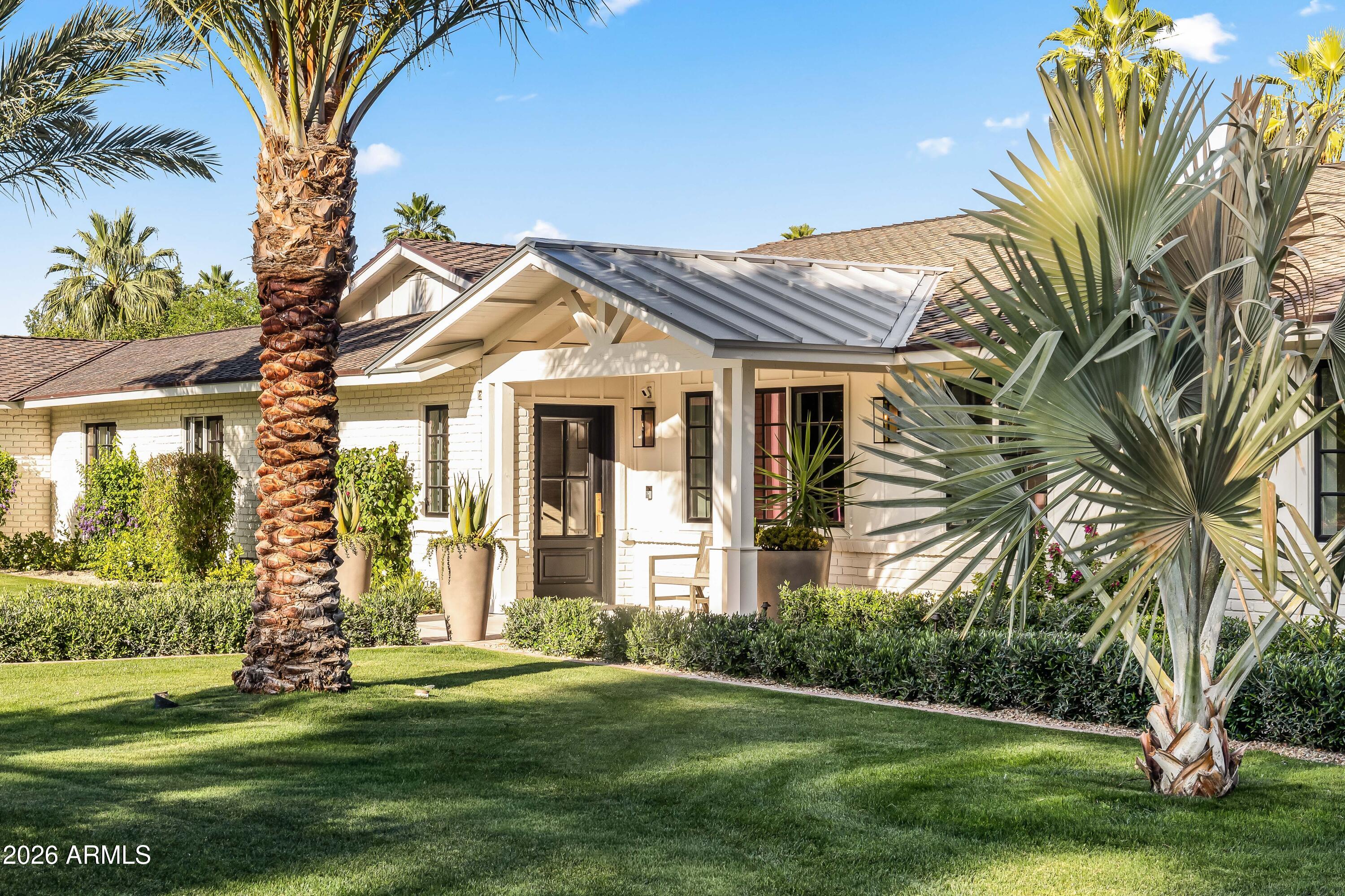 Situated in the heart of Paradise Valley on an expansive 0.83-acre lot, this fully reimagined estate offers a rare blend of refined design, modern functionality, and resort-style living. Surrounded by lush, mature landscaping and framed by mountain views, the home delivers both privacy and proximity-just minutes from world-class resorts, golf, fine dining, Old Town Scottsdale and Fashion Square. Extensively renovated with a comprehensive, high-quality transformation, nearly every surface, system, and finish has been thoughtfully curated to create a cohesive, move-in-ready residence. Interior finishes include new hardwood flooring, designer lighting and fixtures, fresh paint and wallpaper, enhanced millwork, and refined architectural details throughout. The living room is anchored by a relocated fireplace with custom stonework, adding warmth and visual impact. The redesigned kitchen serves as the centerpiece of the home, featuring custom cabinetry, striking stone countertops with a full-height backsplash, a waterfall-edge island, and top-tier appliances including Sub-Zero, Wolf, and Bosch. A beautifully updated butler's pantry and custom California Closets pantry provide exceptional functionality and storage. The private guest suite offers its own sitting area, built-in cabinetry, and mini refrigerator--ideal for extended stays or multigenerational living. All bathrooms have been thoughtfully renovated, including a luxurious primary suite with elevated finishes and sophisticated detailing. Designed for seamless indoor-outdoor living, the backyard has been transformed into a true retreat, complete with a fully renovated pool, expanded patio, new spa, outdoor kitchen, cedar outdoor shower, and multiple gathering spaces enhanced by all-new landscape and exterior lighting. Additional upgrades include a whole-home water filtration system, integrated AV and security systems, new skylights, and a redesigned front entry with a standing seam metal roof. The extensively renovated grounds feature new irrigation and curated plantings, including palms, oaks, olive hedging, and over 100 sour orange trees. A fully upgraded 4-car garage with epoxy flooring, custom cabinetry, sink, and enhanced lighting completes the property. This is a rare opportunity to own a turnkey, design-forward home in one of Paradise Valley's most desirable locations.